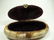 OVAL CARVED BONE BOX WITH BRASS INLAY, APPROX 6 1/8" X - 3