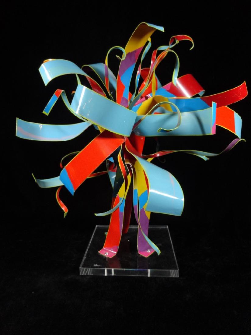 DOROTHY GILLESPIE (AMERICAN 1920-2012), STARBURST: DOROTHY GILLESPIE (AMERICAN 1920-2012), STARBURST SCULPTURE, BLUE / RED & MULTICOLOR ENAMELED ALUMINUM RIBBONS ON LUCITE BASE, WITH LABEL: "AN ORIGINAL WORK BY DOROTHY GILLESPIE, AUTHENTICATED BY HER 
