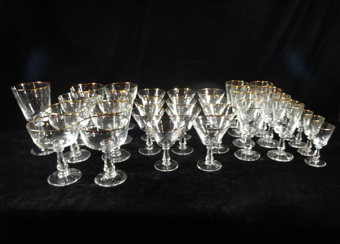 33 PC GOLD RIM STEMWARE, INCLUDES 1 GLASS APPROX 6: 33 PC GOLD RIM STEMWARE, INCLUDES 1 GLASS APPROX 6 7/8"H, 8 SHERBET GLASSES APPROX 5 1/8"H, 10 MARTINI GLASSES APPROX 4 3/8"H, 8 WINE GLASSES APPROX 4 1/4"H & 6 CORDIAL GLASSES APPROX 3 3/4"H, SKU233.