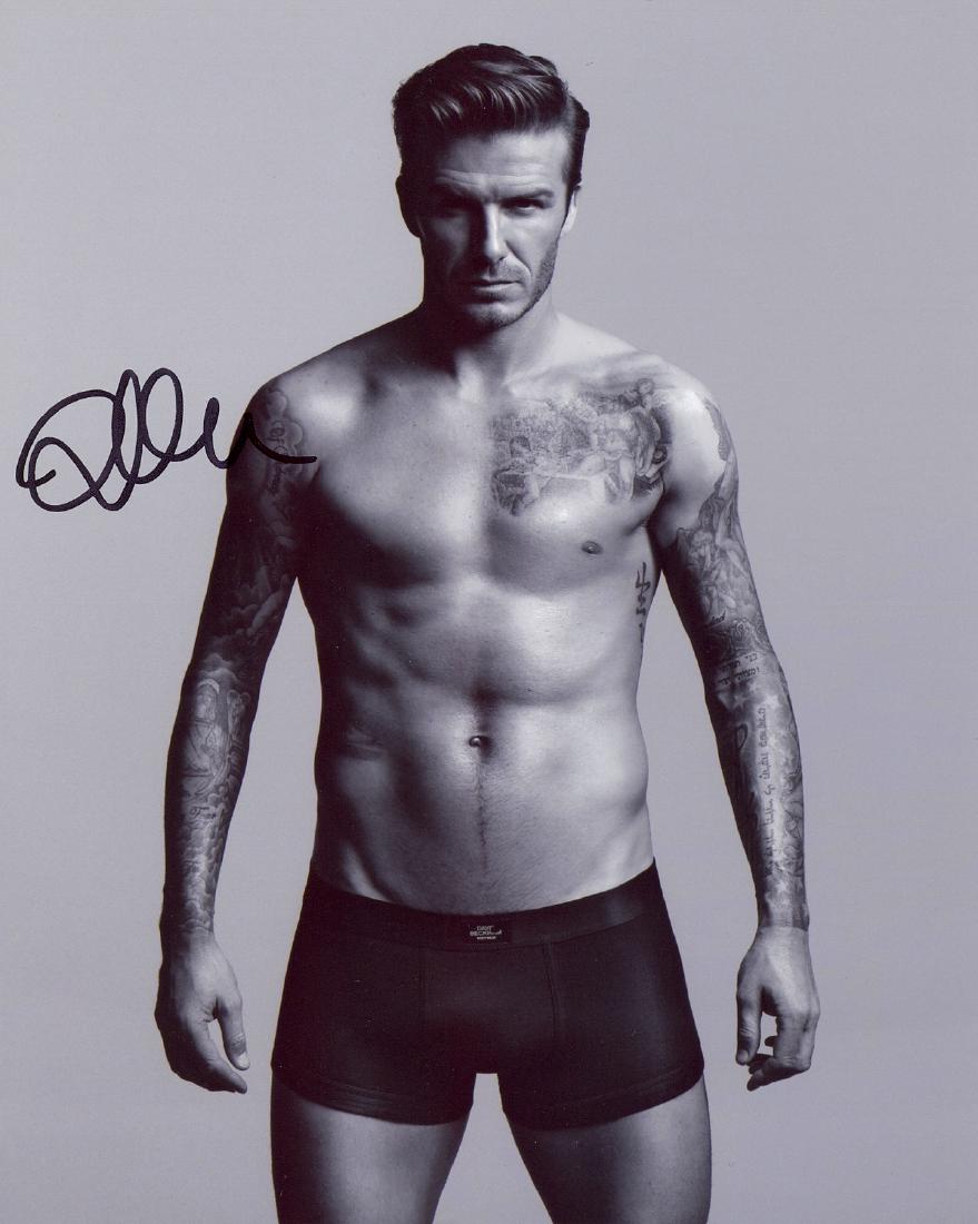 BECKHAM DAVID: (1975- ): BECKHAM DAVID: (1975- ) English Footballer. Signed 8 x 10 photograph by Beckham, the promotional image showing Beckham standing in a three quarter top less length pose. Signed in bold black ink to a c