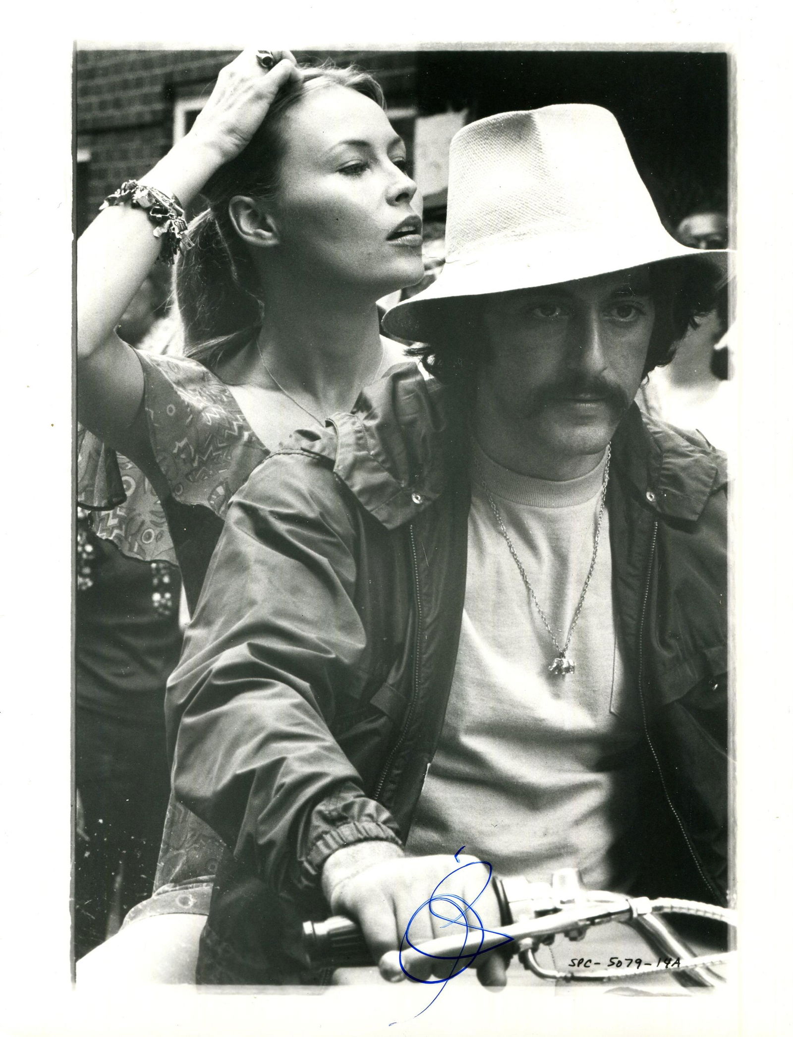 PACINO AL: (1940- ): PACINO AL: (1940- ) American actor, Academy Award winner. Signed 7 x 9.5 photograph of Pacino in a half-length pose, in costume as Frank Serpico, as he rides on a bike accompanied by Cornelia Sharpe (