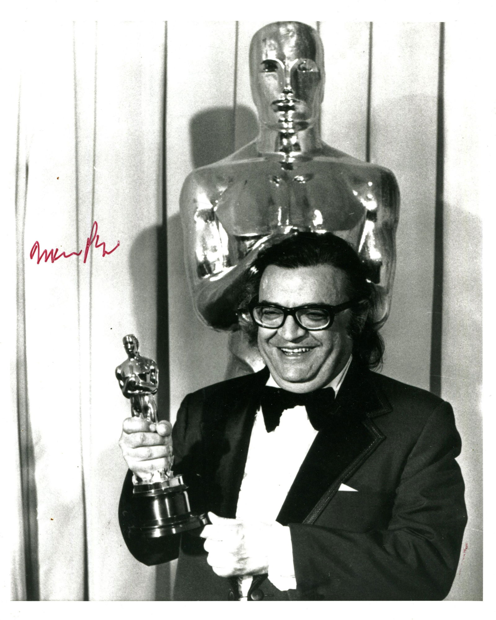 PUZO MARIO: (1920-1999): PUZO MARIO: (1920-1999) American author and screenwriter of crime novels involving the mafia, most notably The Godfather (1969). Signed 8 x 10 photograph of Puzo standing in a half-length pose holding