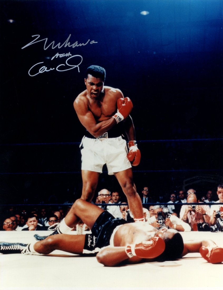 ALI MUHAMMAD: (1942- ) American Boxer, World He: ALI MUHAMMAD: (1942- ) American Boxer, World Heavyweight Champion. Signed colour 8 x 10 photograph, a classic image of Ali standing in a full length pose over Sonny Liston who lies on the canvas of th