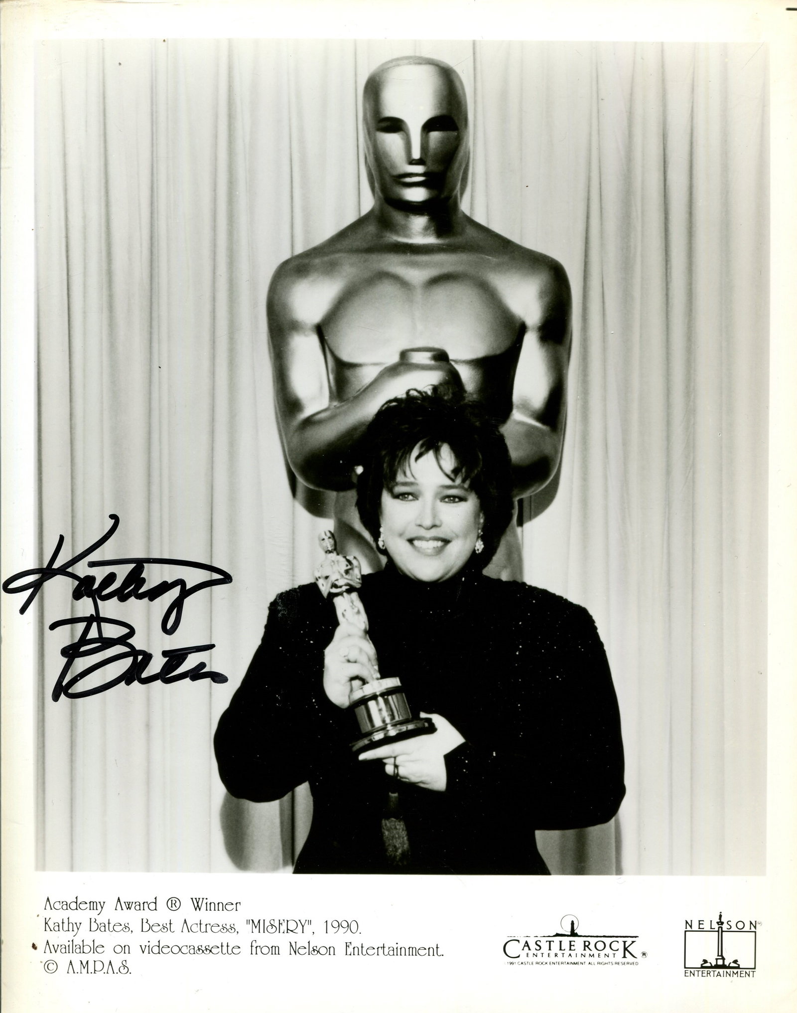 BATES KATHY: (1948- ): BATES KATHY: (1948- ) American actress, Academy Award winner for Best Actress in 1990 for her role as Annie Wilkes in Misery. Signed 8 x 10 photograph of Bates standing in a half-length pose holding h