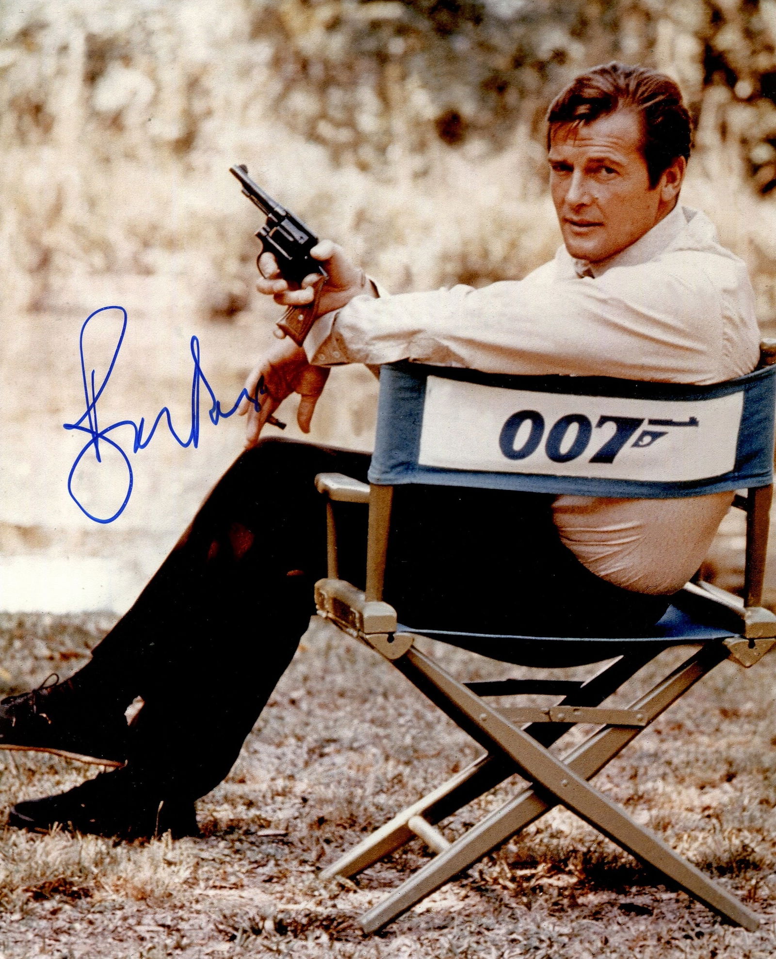 MOORE ROGER: (1927-2017): MOORE ROGER: (1927-2017) English actor, famous for his portrayal of the fictional British secret agent James Bond in seven films from 1973-85. Signed colour 8 x 10 photograph of Moore seated outdoors