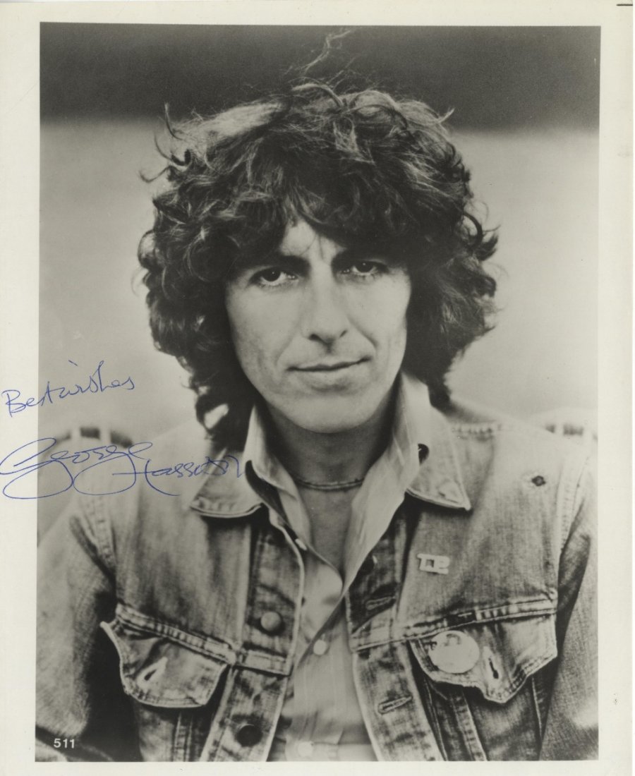 HARRISON GEORGE: (1943-2001) English Guitarist, a membe: HARRISON GEORGE: (1943-2001) English Guitarist, a member of The Beatles. Signed 8 x 10 photograph of Harrison in a head and shoulders pose wearing a denim jacket. Signed in blue ink across a clear are