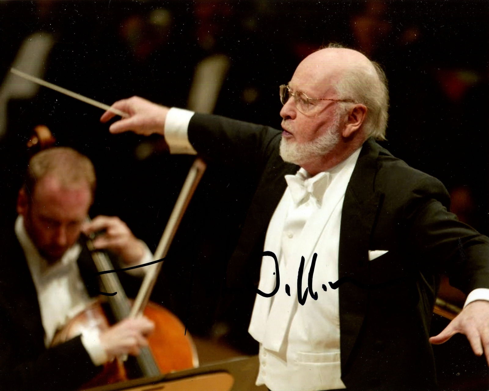 WILLIAMS JOHN: (1932- ): WILLIAMS JOHN: (1932- ) American composer of film scores, Academy Award winner. Signed colour 10 x 8 photograph of Williams standing in a half-length pose conducting an orchestra. Signed in black ink