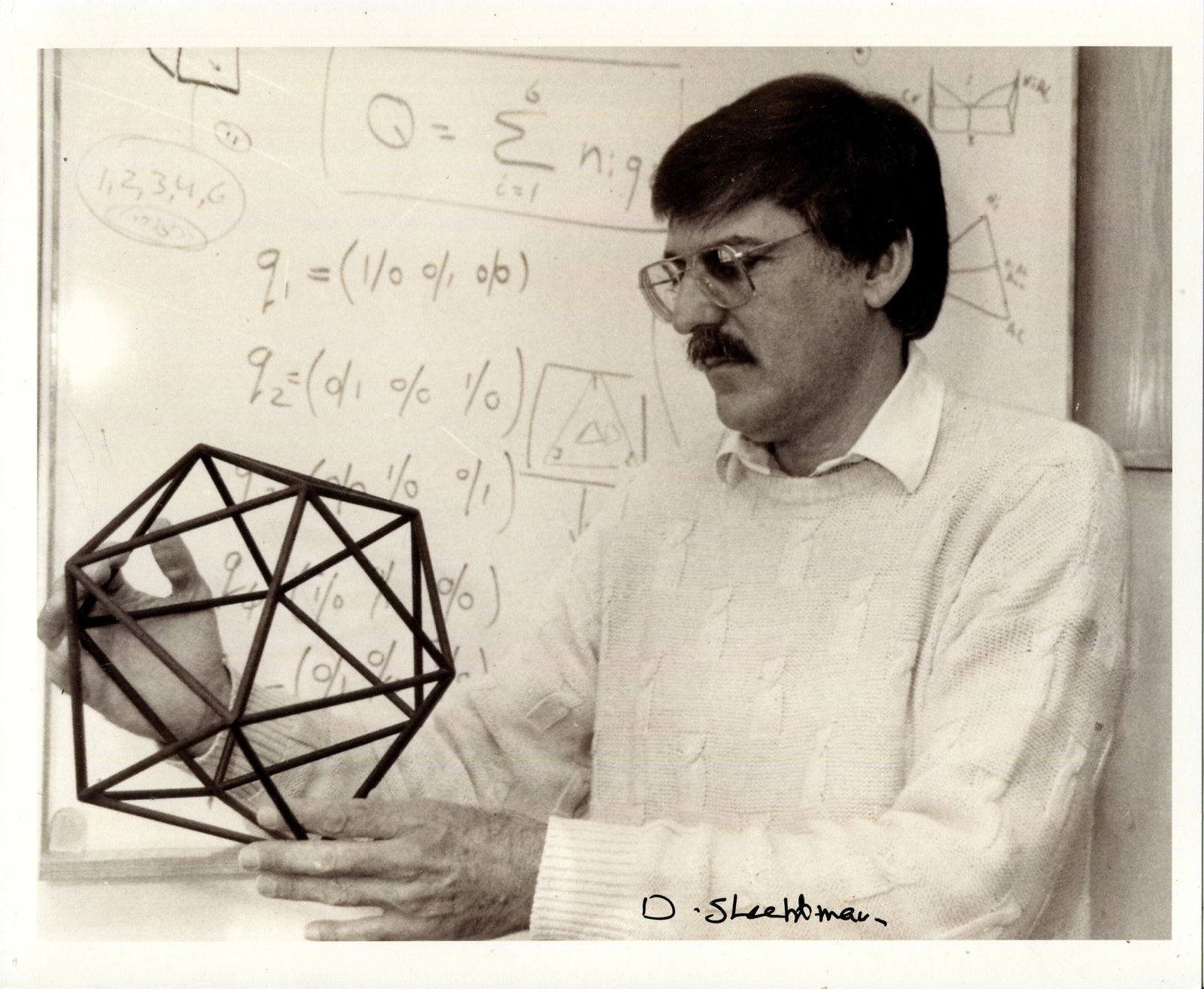 SHECHTMAN DAN: (1941- ): SHECHTMAN DAN: (1941- ) Israeli scientist, Nobel Prize winner for Chemistry, 2011. Signed 10 x 8 photograph of the scientist standing in a half-length pose as he ponders the model in his hands, and wi