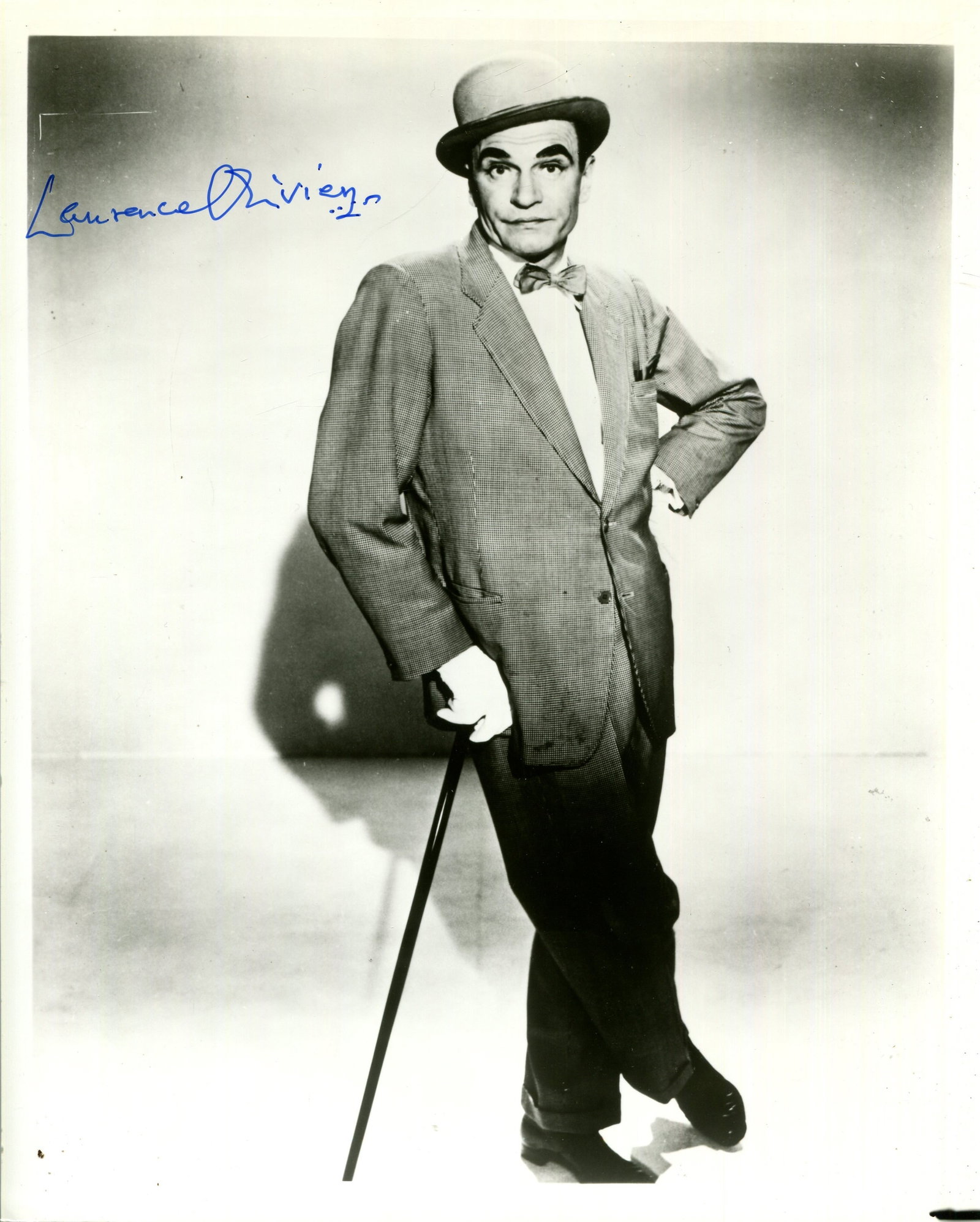 OLIVIER LAURENCE: (1907-1989): OLIVIER LAURENCE: (1907-1989) English actor, Academy Award winner. Signed 8 x 10 photograph of Olivier standing in a full-length pose in costume as the third-rate Music Hall stage performer Archie Ric