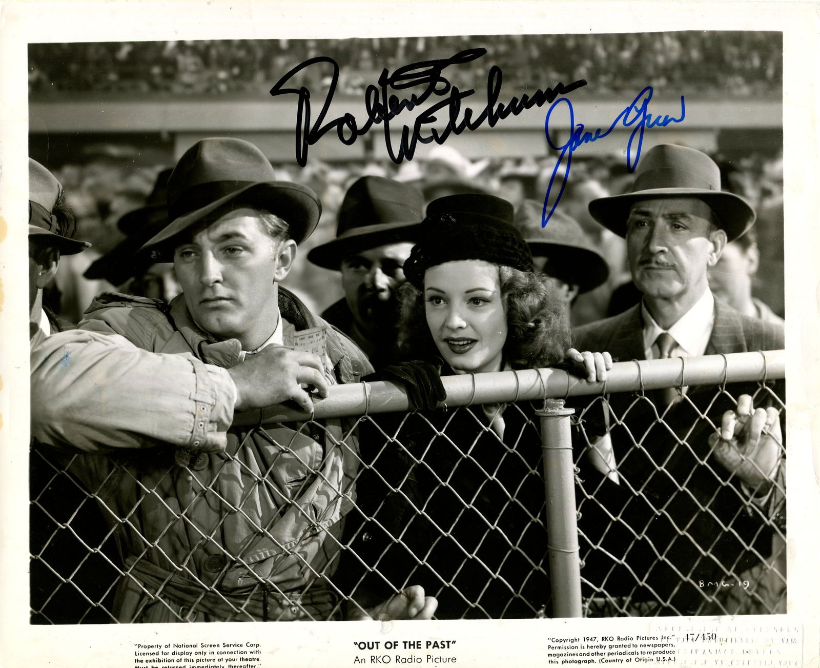 OUT OF THE PAST: MITCHUM & GREER: OUT OF THE PAST: Signed 10 x 8 photograph by both Robert Mitchum (Jeff Bailey) and Jane Greer (Kathie Moffat) individually, the image depicting the actors in half-length poses leaning over a wire