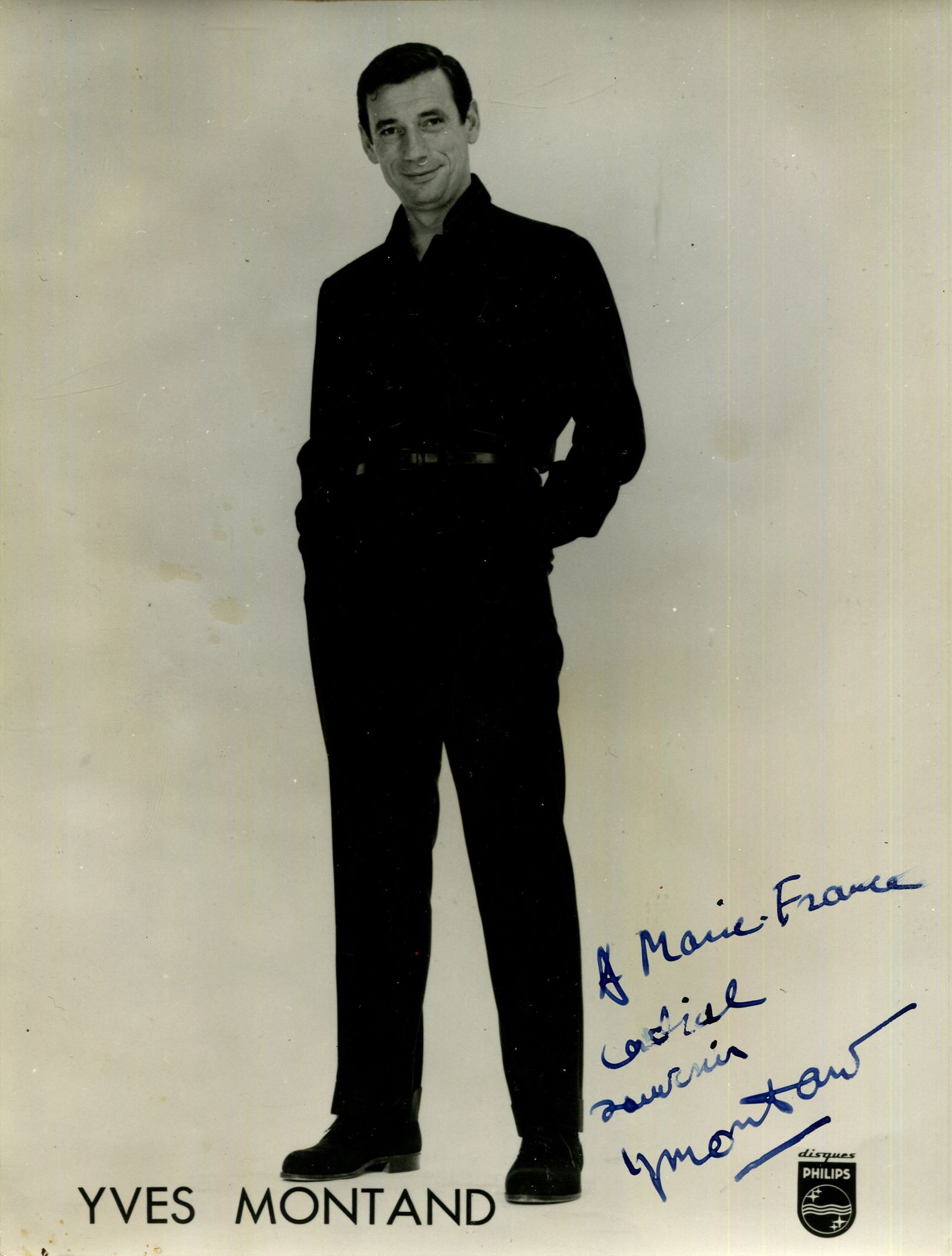MONTAND YVES: (1921-1991): MONTAND YVES: (1921-1991) French actor. Vintage signed and inscribed 7 x 9.5 photograph, the Philips Records promotional image depicting Montand standing in a full-length pose wearing dark clothing. S