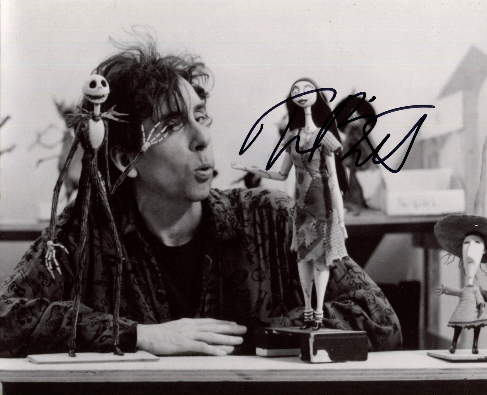 BURTON TIM: (1958- ): BURTON TIM: (1958- ) American film director. Signed 10 x 8 photograph of Burton, the image showing the film director seated in a head and shoulders pose, before a table with models of his film The Nig