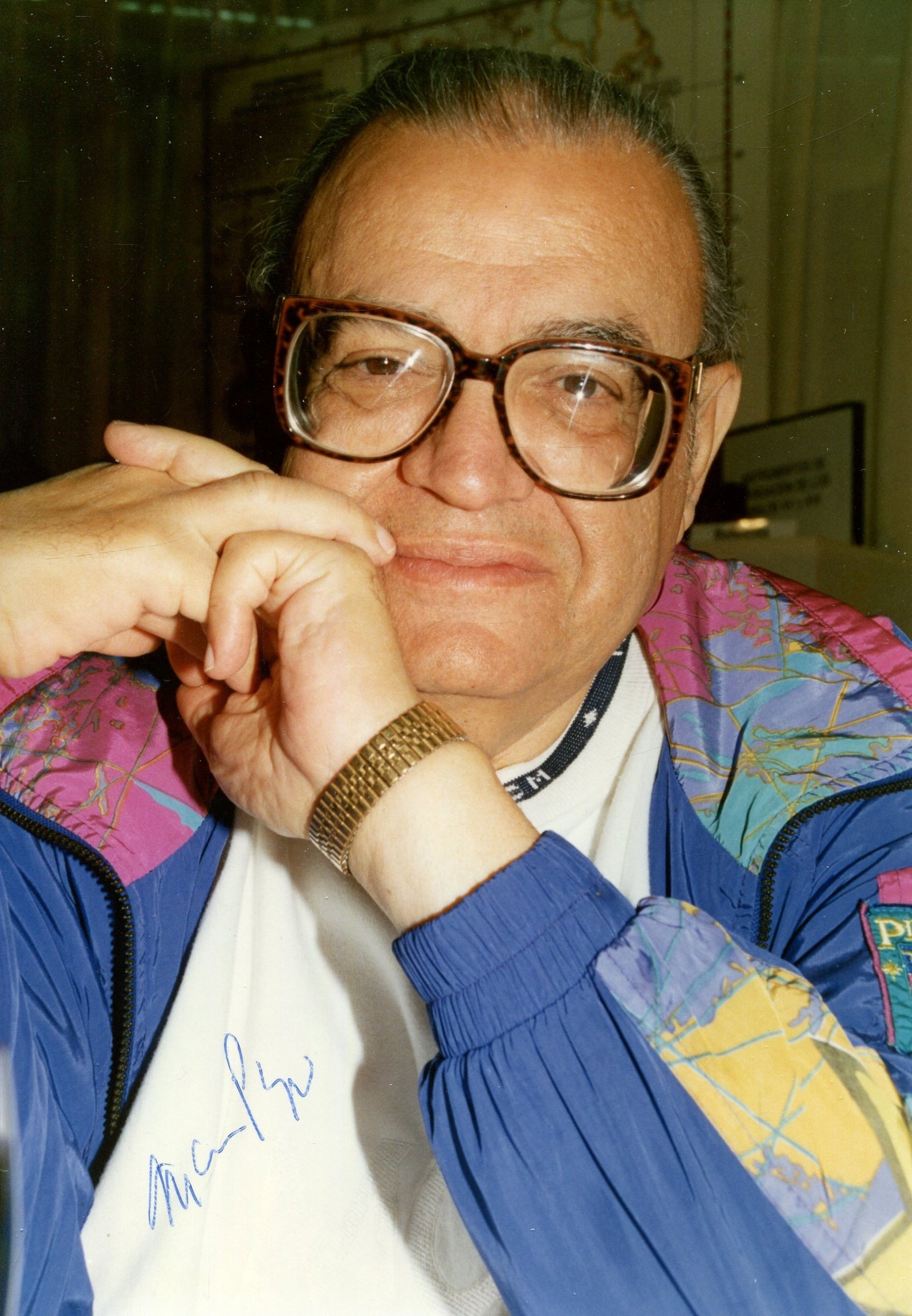 PUZO MARIO: (1920-1999): PUZO MARIO: (1920-1999) American author and screenwriter of crime novels involving the mafia, most notably The Godfather (1969). Signed colour 5 x 7 photogreaph, the candid image depicting Puzo in a h