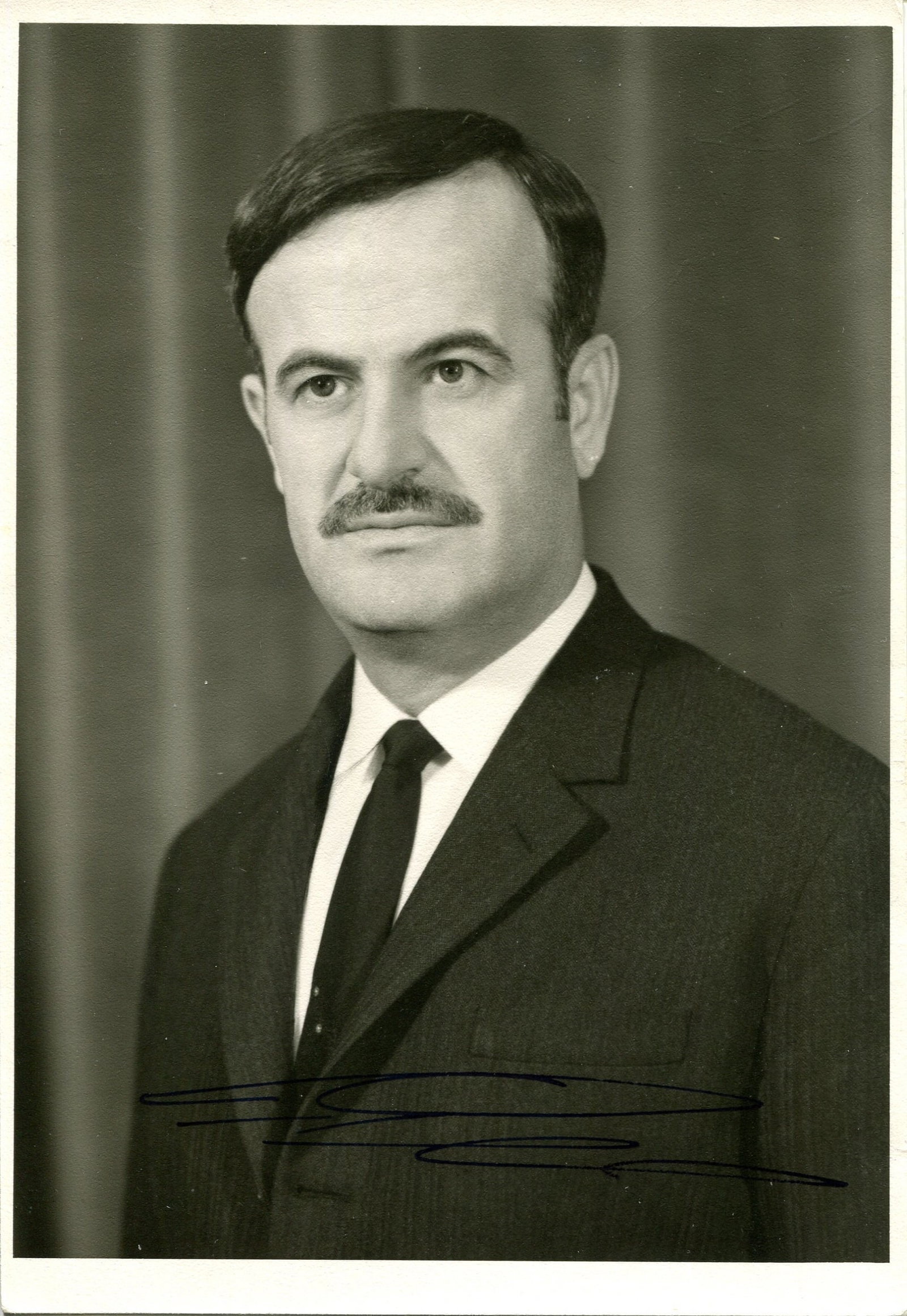 AL-ASSAD HAFEZ: (1930-2000): AL-ASSAD HAFEZ: (1930-2000) Syrian statesman and military officer who served as Prime Minister of Syria 1970-71 and as President of Syria 1971-2000. Vintage signed 5 x 7 photograph of Assad in a