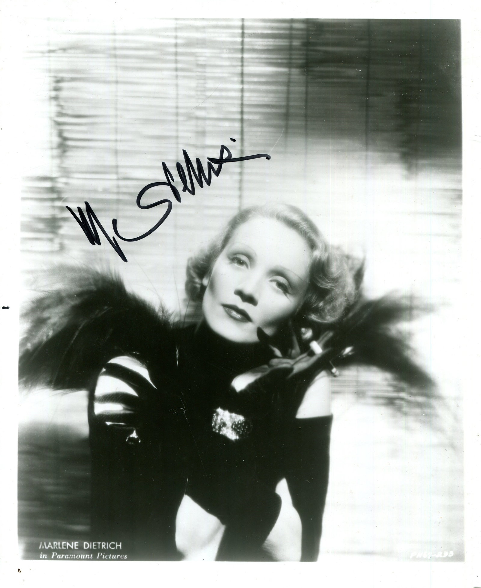 DIETRICH MARLENE: (1901-1992): DIETRICH MARLENE: (1901-1992) German-born American actress and singer. Signed 8 x 10 photograph of the actress in an appealing half-length pose wearing a glamorous dress and black evening gloves.