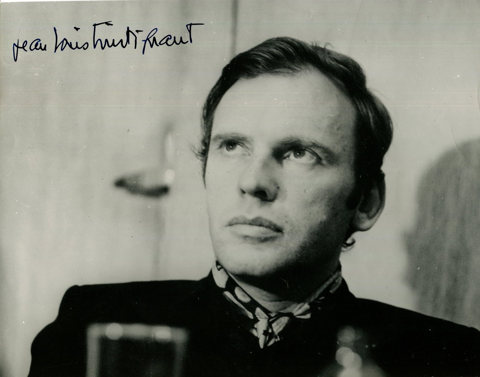 TRINTIGNANT JEAN-LOUIS: (1930-2022): TRINTIGNANT JEAN-LOUIS: (1930-2022) French Actor. A very fine signed 9.5 x 7.5 photograph, the unusual image showing Trintignant in a head and shoulders pose, in his role as Simon Duroc, in a scene