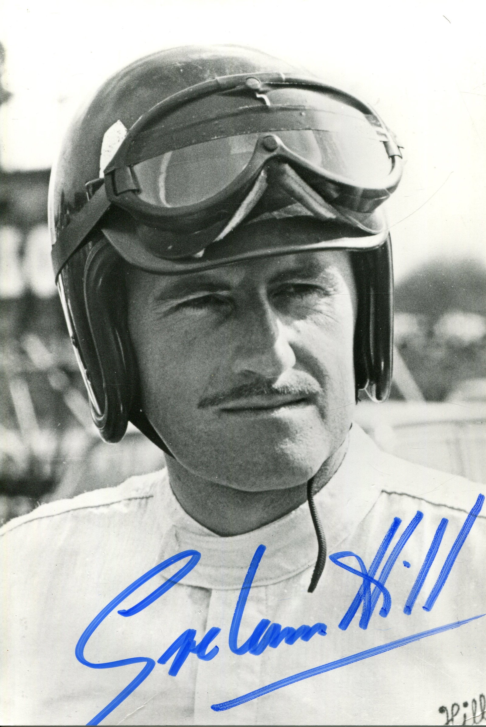 HILL GRAHAM: (1929-1975): HILL GRAHAM: (1929-1975) English motor racing driver, Formula One World Champion 1962 & 1968. Signed 4 x 6 photograph of Hill in a head and shoulders pose wearing his racing helmet and goggles.