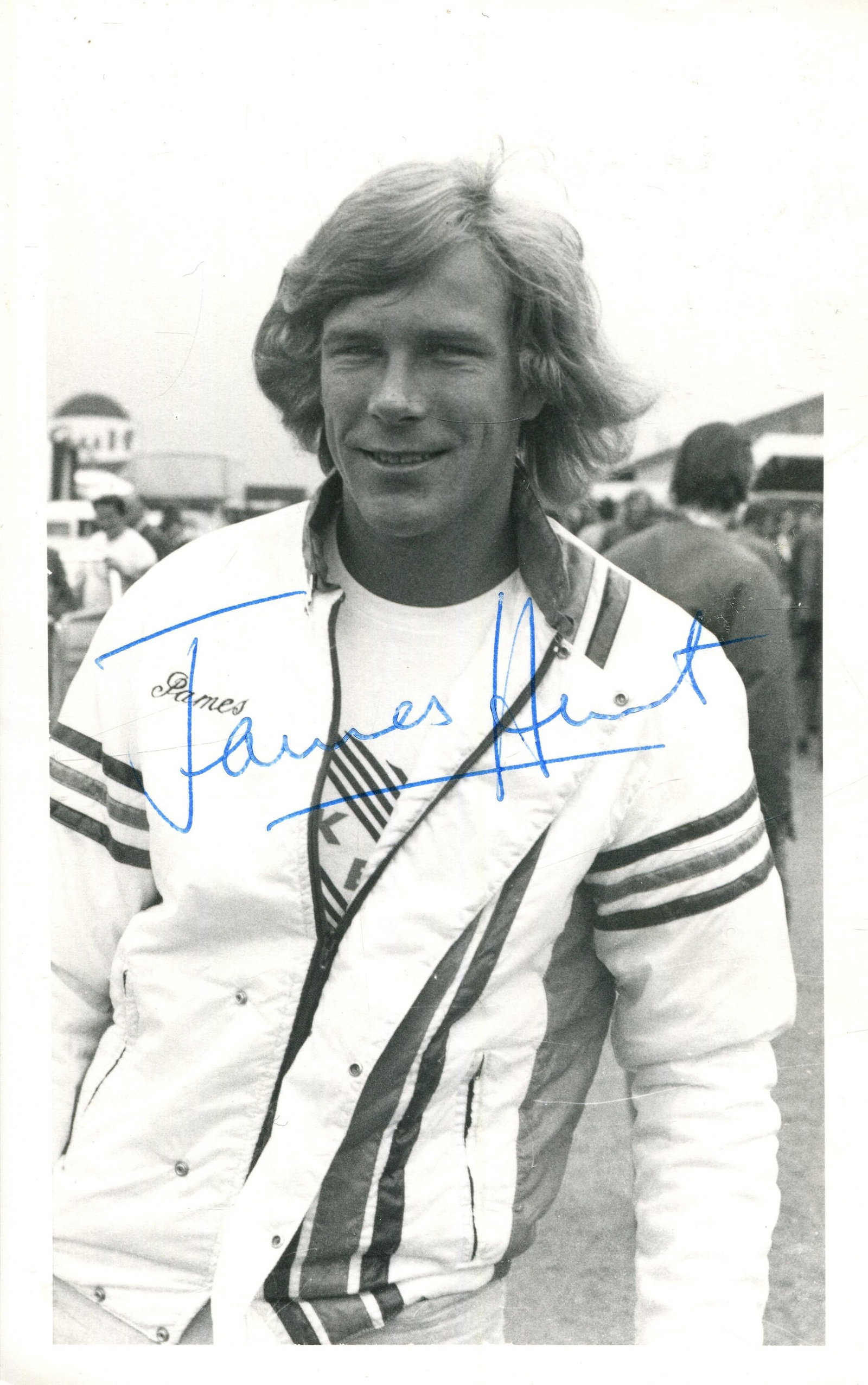 HUNT JAMES: (1947-1993): HUNT JAMES: (1947-1993) British motor racing driver, Formula One World Champion 1976. Signed 3.5 x 5.5 photograph of Hunt standing outdoors in a half-length pose. Signed in blue ink with his name