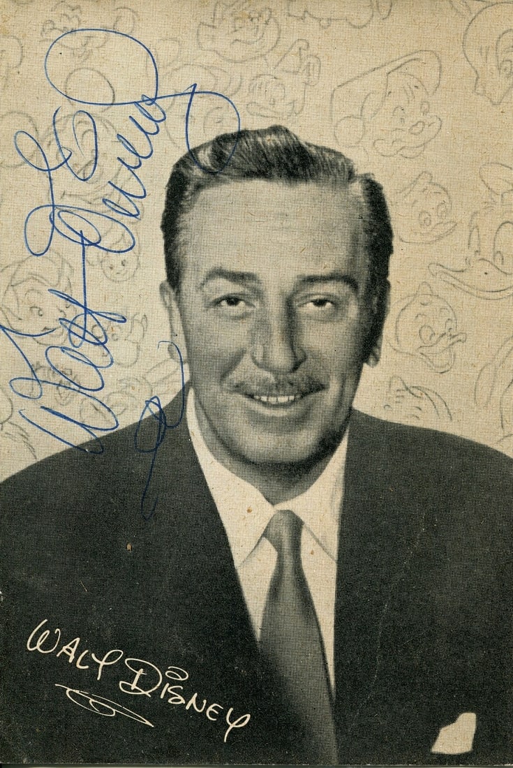DISNEY WALT: (1901-1966): DISNEY WALT: (1901-1966) American animator, Academy Award winner. Vintage signed 4 x 5.5 cardstock photograph of Disney in a head and shoulders pose against a backdrop of drawings of various Disney
