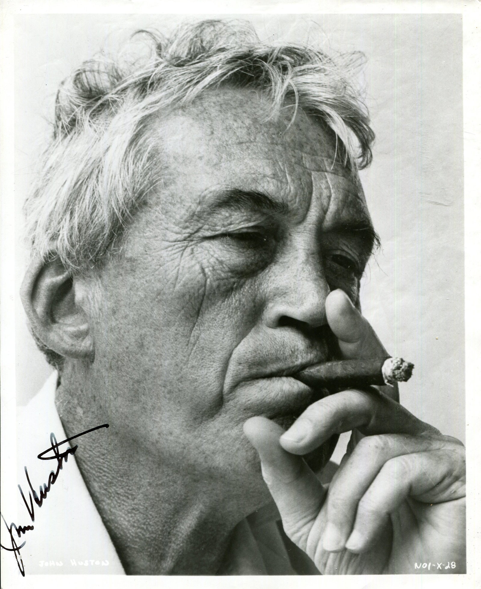 HUSTON JOHN: (1906-1987): HUSTON JOHN: (1906-1987) American film director and actor, Academy Award winner. Signed 8 x 10 photograph of Huston in a close-up portrait pose smoking a cigar whilst on location in Puerto Vallarta,