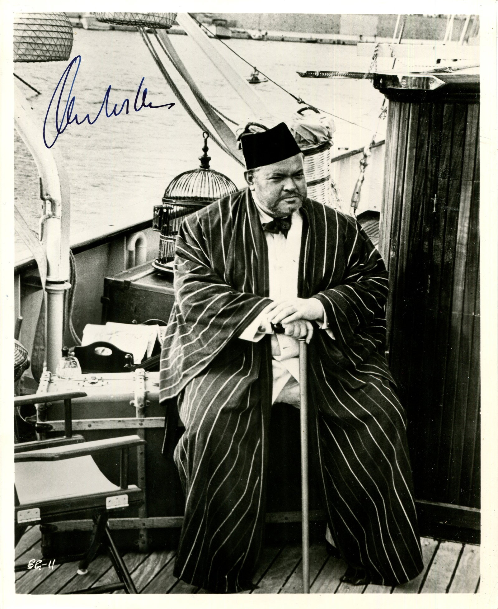 WELLES ORSON: (1915-1985): WELLES ORSON: (1915-1985) American actor and film director, the recipient of an Honorary Academy Award in 1970. A good vintage signed 8 x 10 photograph of Welles seated in a full-length pose on a