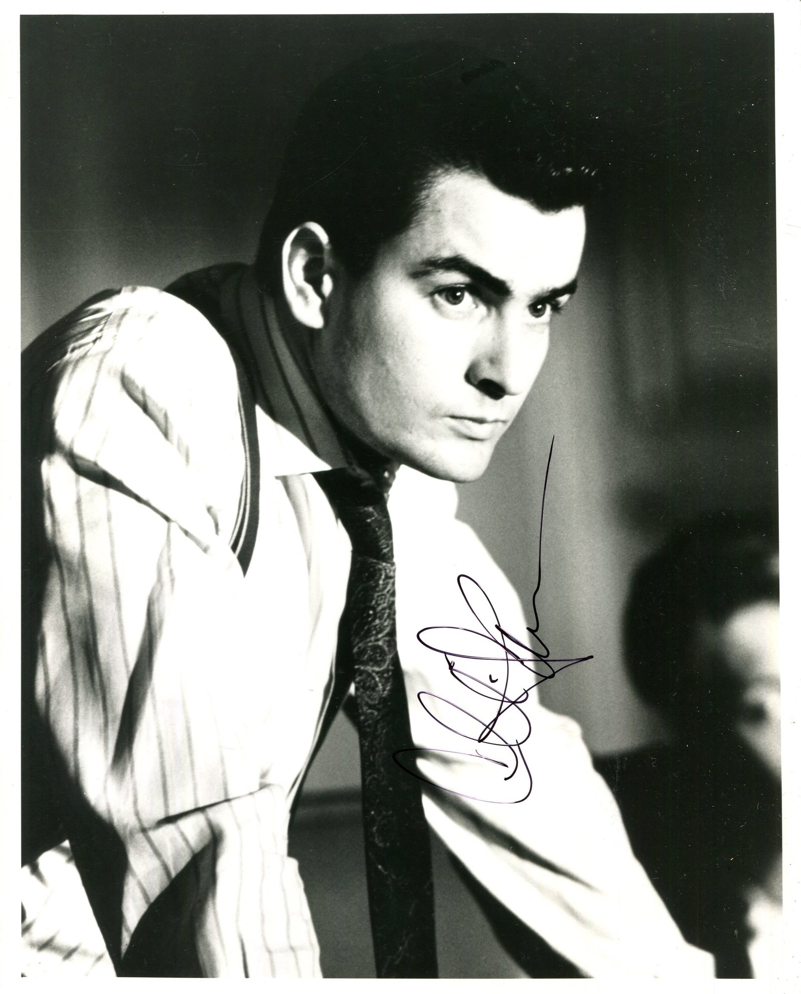 SHEEN CHARLIE: (1965- ): SHEEN CHARLIE: (1965- ) American Actor. Signed 8 x 10 photograph of Sheen in a half-length pose in costume as Bud Fox from the American crime drama film Wall Street (1987). Signed in black pen ink to