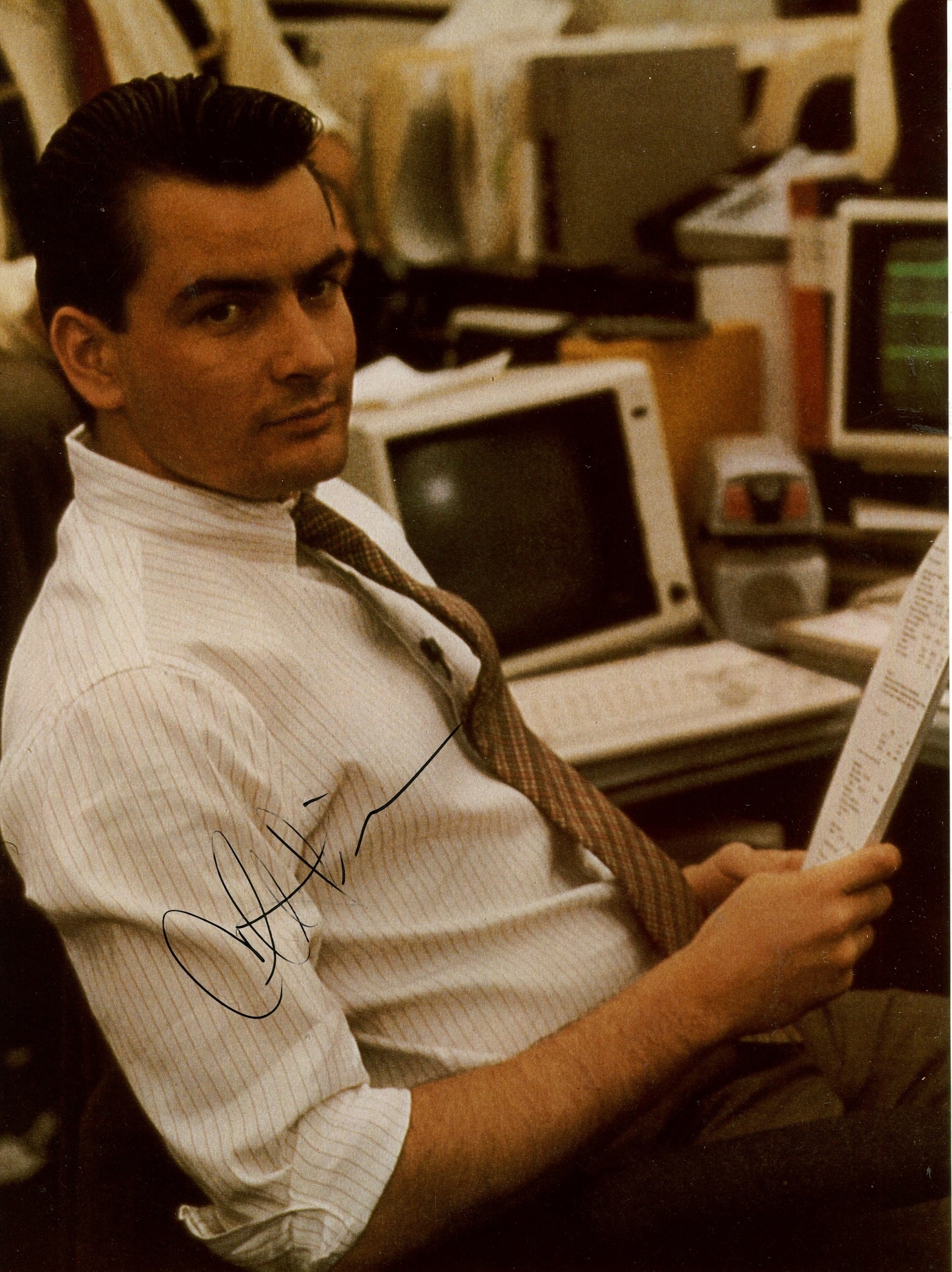 SHEEN CHARLIE: (1965- ): SHEEN CHARLIE: (1965- ) American Actor. Signed colour 8 x 10 photograph of Sheen seated in a half-length pose in costume as Bud Fox from the American crime drama film Wall Street (1987). Signed in