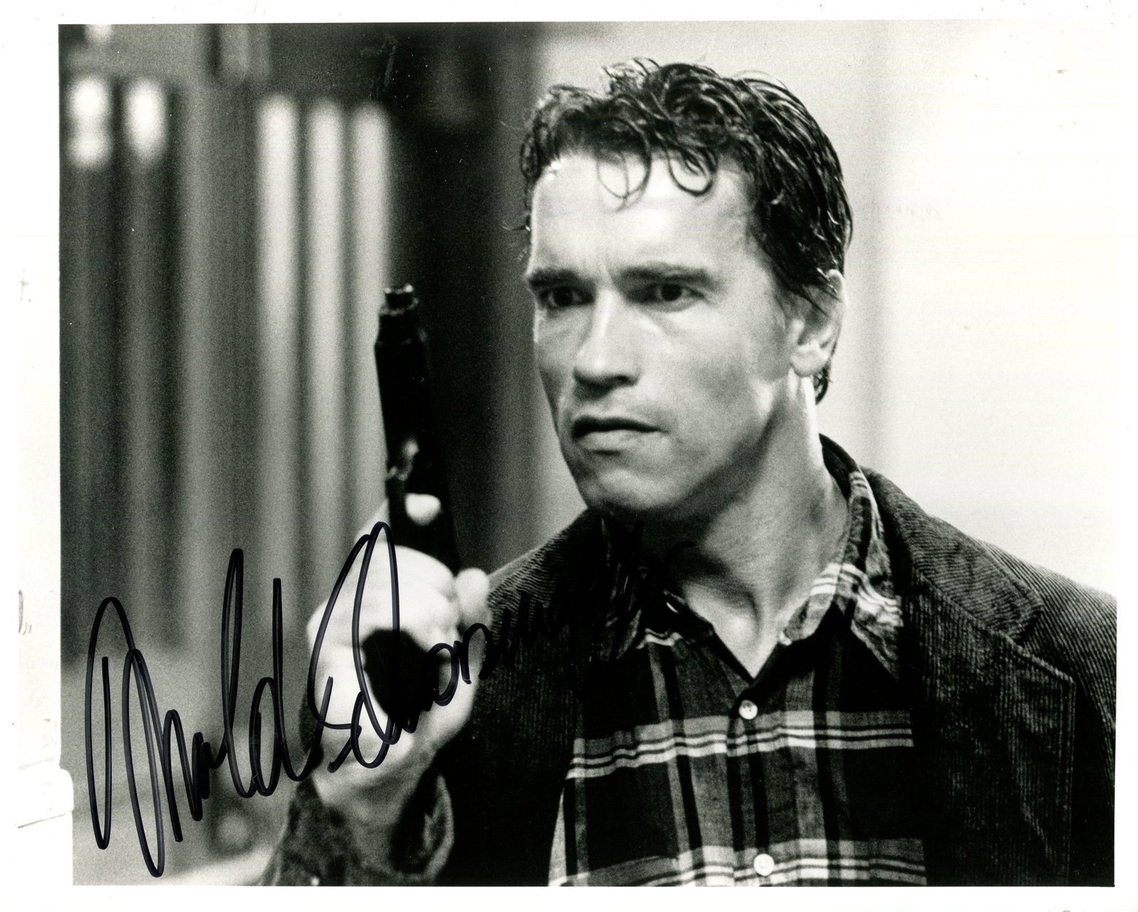 SCHWARZENEGGER ARNOLD: (1947- ): SCHWARZENEGGER ARNOLD: (1947- ) Austrian-American Actor, former professional bodybuilder, and Politician. Signed 10 x 8 photograph of the actor standing in a head and shoulders pose, aiming a pistol,