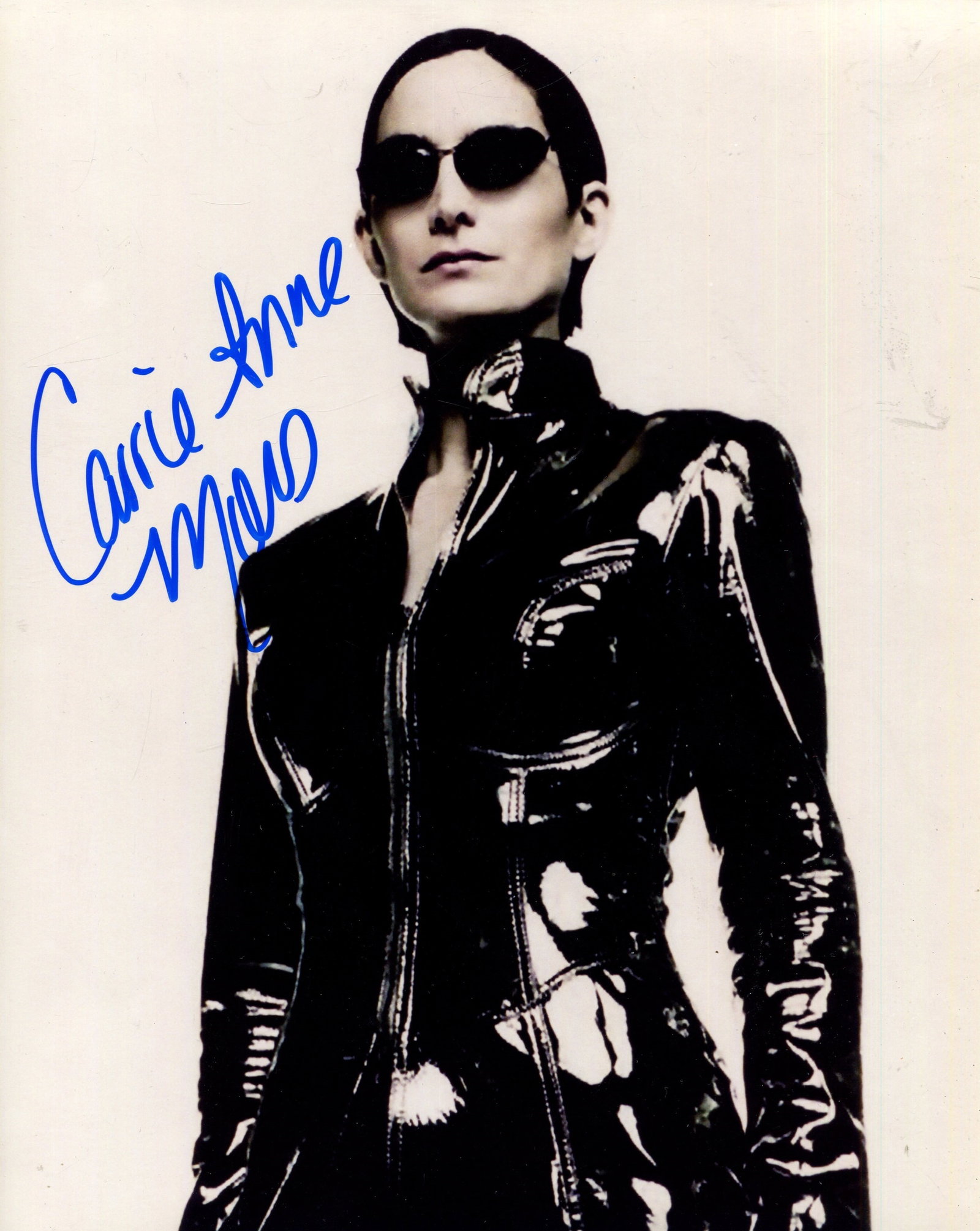 MOSS CARRIE-ANNE: (1967- ): MOSS CARRIE-ANNE: (1967- ) Canadian-American actress. She rose to international prominence for her role of Trinity in The Matrix series. A good signed 8 x 10 colour photograph by Moss, the image