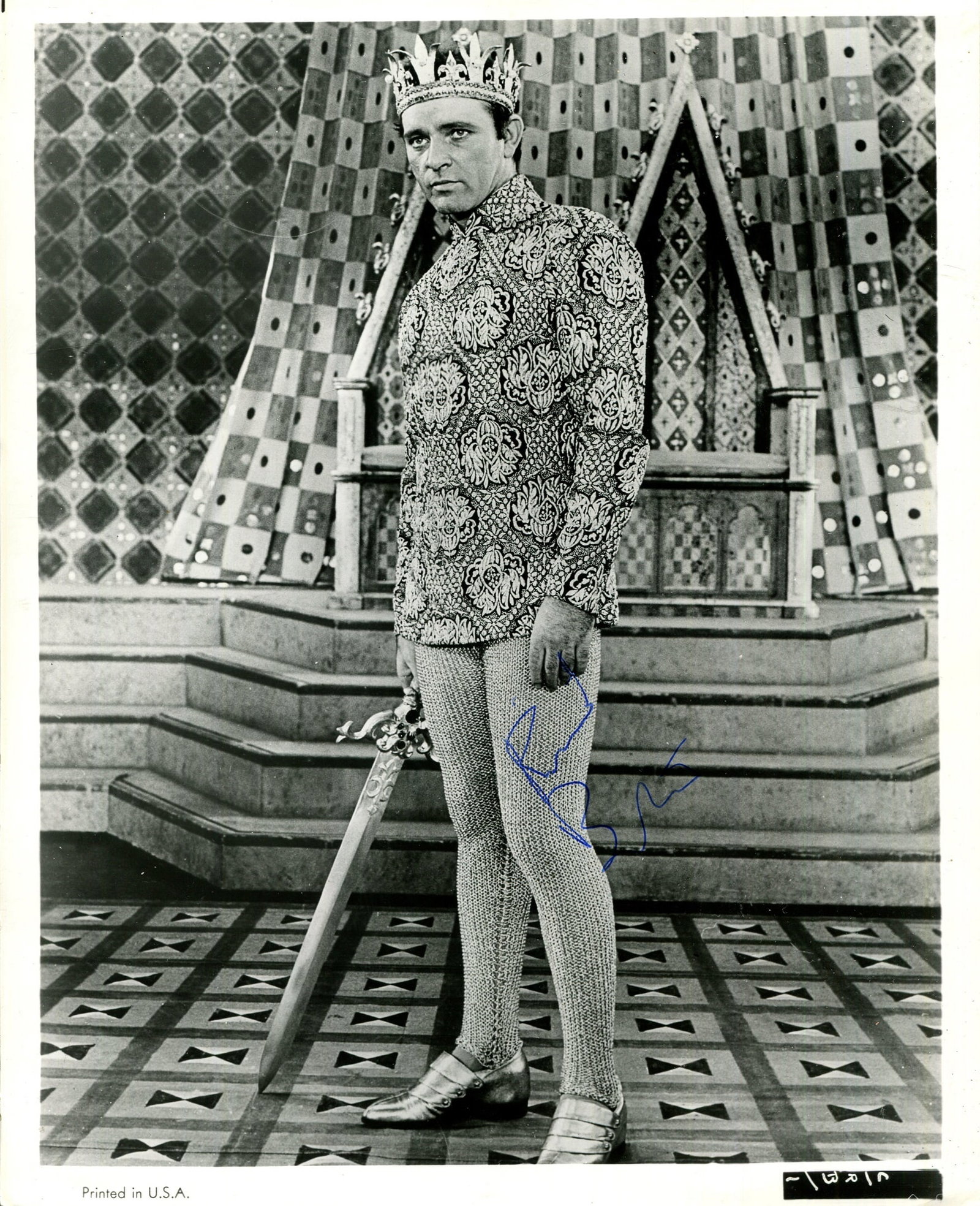 BURTON RICHARD: (1925-1984): BURTON RICHARD: (1925-1984) Welsh actor. A good vintage signed 8 x 10 photograph of Burton standing in a full-length pose in costume as King Arthur, holding a sword in one hand, from the original