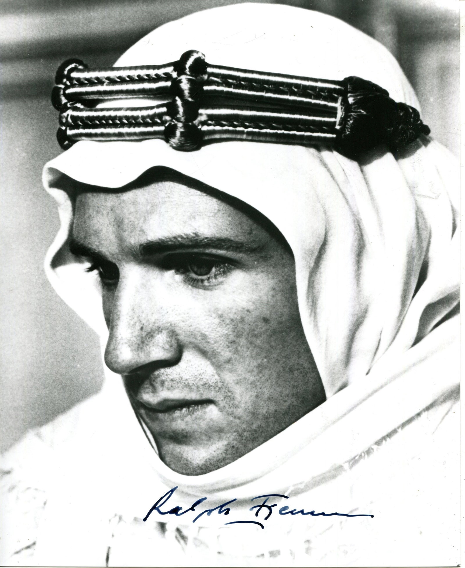 FIENNES RALPH: (1962- ): FIENNES RALPH: (1962- ) English actor. Signed 8 x 10 photograph of Fiennes in a close-up head and shoulders pose in costume as the British Army officer T. E. Lawrence from the British television film