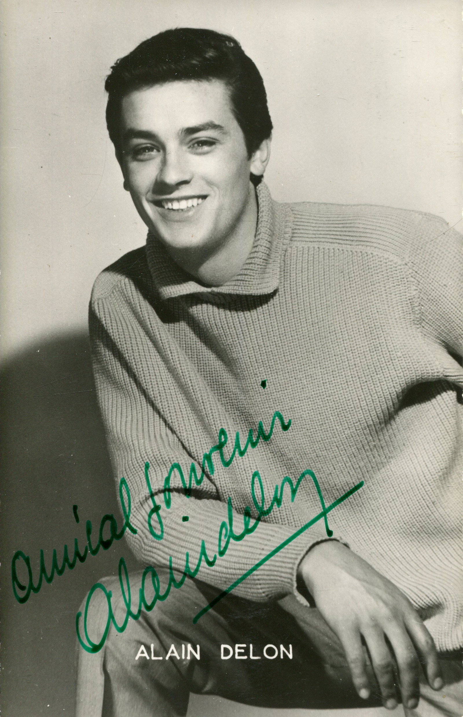 DELON ALAIN & BELMONDO JEAN PAUL:: DELON ALAIN & BELMONDO JEAN PAUL: Alain Delon (1935-2024) French actor. Vintage signed postcard photograph of the young, handsome actor in a three-quarter length pose. Photograph by Sam Levin. Signed