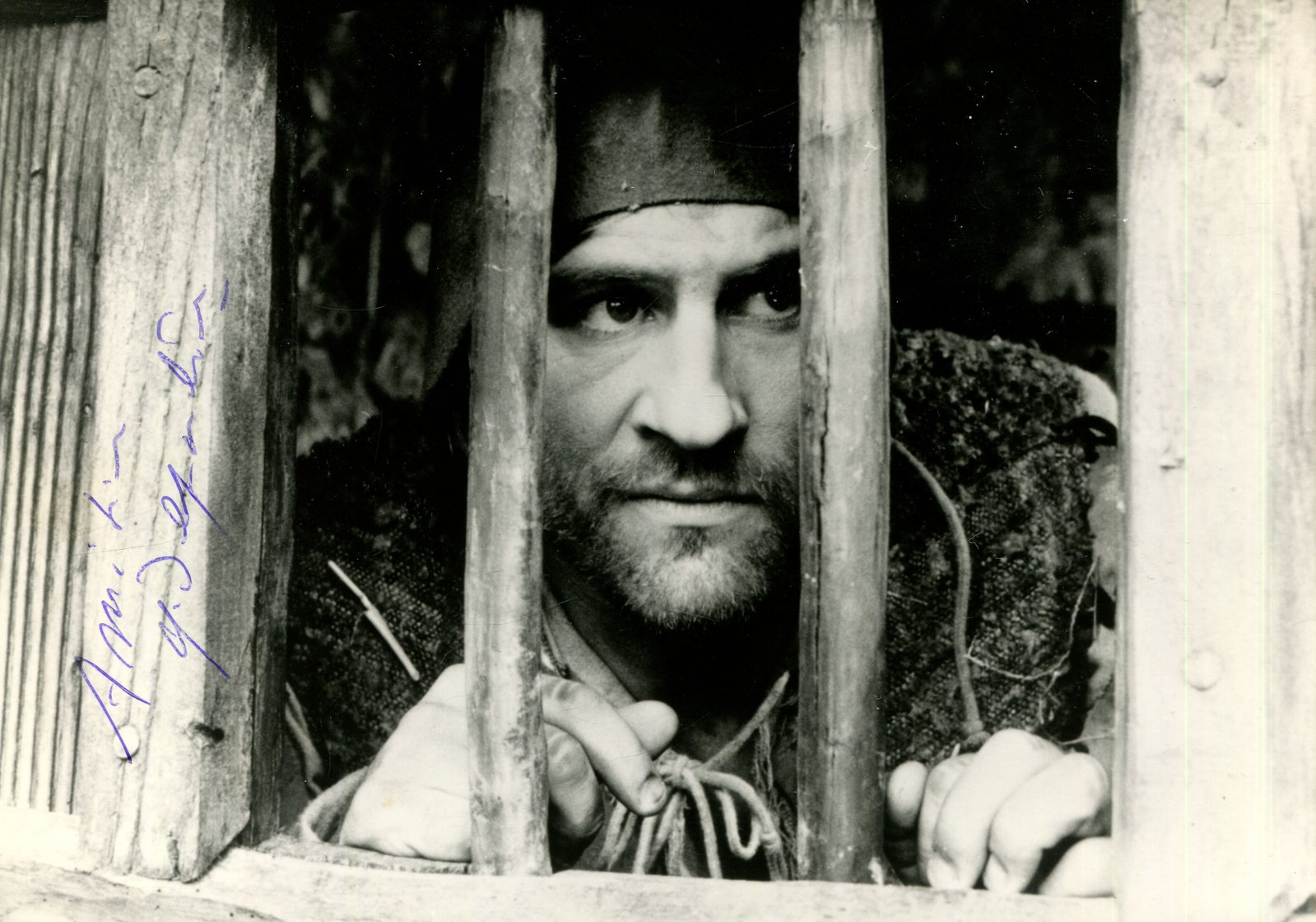 DEPARDIEU GERARD: (1948- ): DEPARDIEU GERARD: (1948- ) French Actor. Signed 7 x 5 photograph by Depardieu, the unusual image showing the French actor behind the bars of a prison window in a head and shoulders pose in a scene of