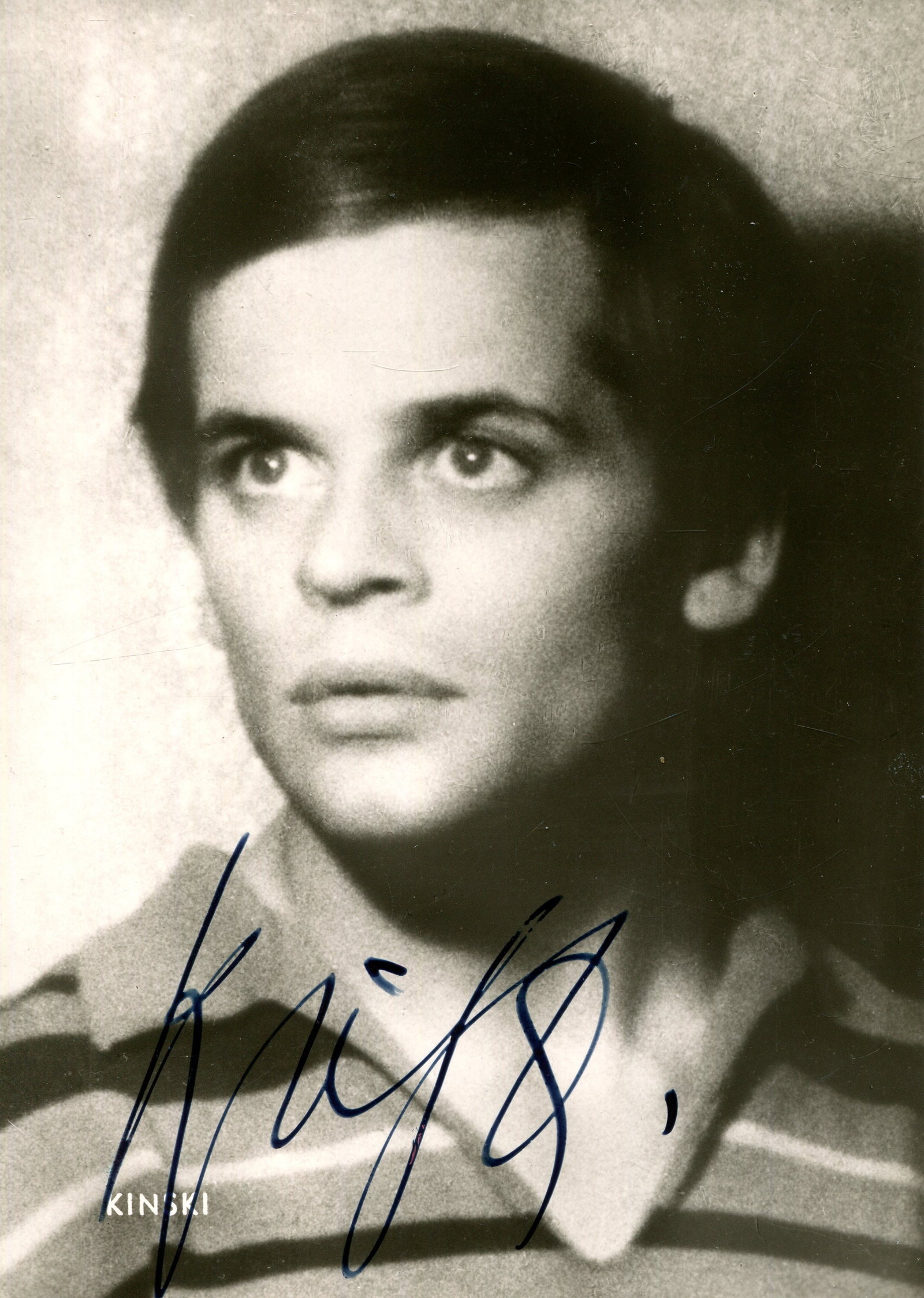 KINSKI KLAUS: (1926-1991): KINSKI KLAUS: (1926-1991) German actor. Signed 4 x 6 postcard photograph of the actor in a head and shoulders pose. Signed (´Kinski´) in bold blue fountain pen ink across a lighter area at