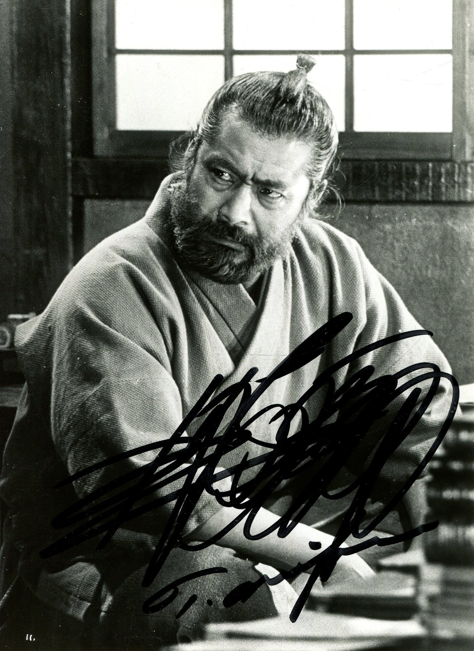 MIFUNE TOSHIRO: (1920-1997): MIFUNE TOSHIRO: (1920-1997) Japanese actor, famous for his roles in Akira Kurosawa’s jidaigeki films. Signed 4.5 x 6 photograph of Mifune in a three-quarter length pose in costume as a samurai.