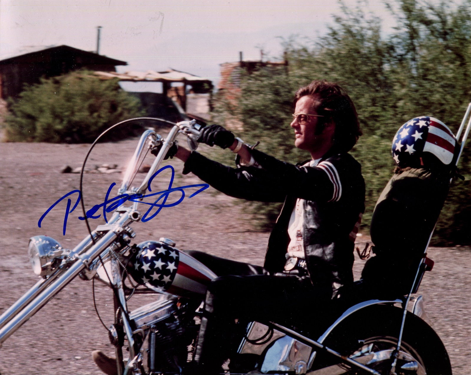 EASY RIDER:: EASY RIDER: A very fine 10 x 8 colour signed photograph by American actor Peter Fonda (1940-2019), the image showing him in a scene of the iconic American film Easy Rider (1969). Signed by Fonda in