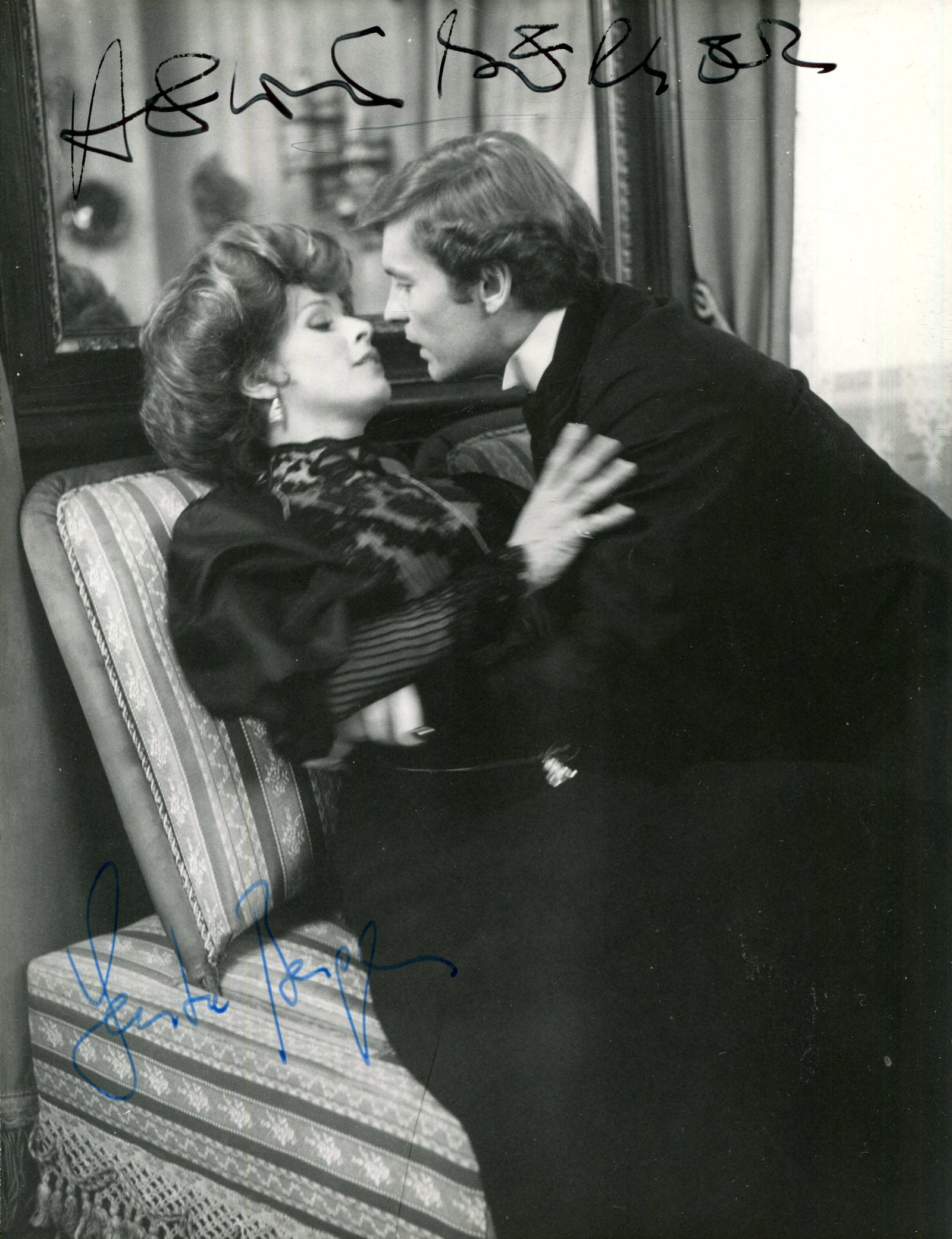 MERRY-GO-ROUND:: MERRY-GO-ROUND: Signed 7 x 9.5 photograph by both Helmut Berger (The Young Man) and Senta Berger (The Young Wife) individually, the image depicting the two actors in a three-quarter length embrace in
