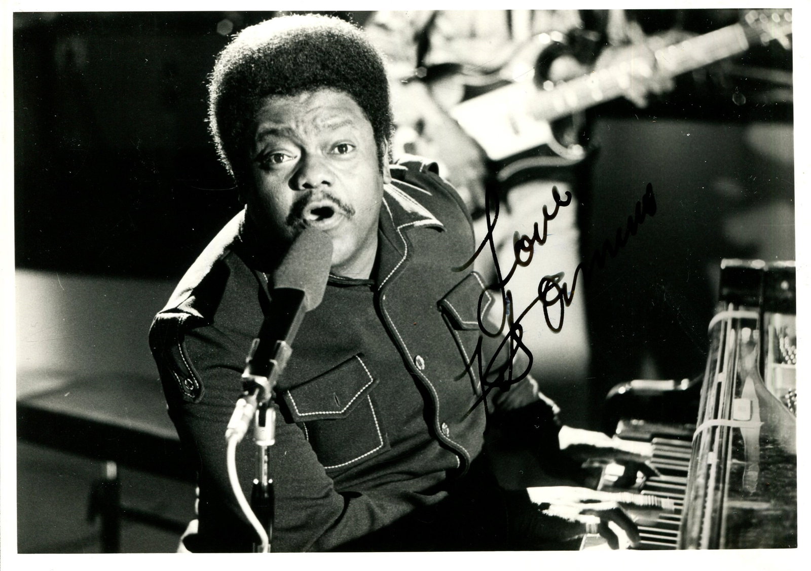 DOMINO FATS: (1928-2017): DOMINO FATS: (1928-2017) American singer-songwriter and pianist, a pioneer of rock and roll music. Signed 7 x 5 photograph of Domino seated in a half-length pose at his piano and singing into a