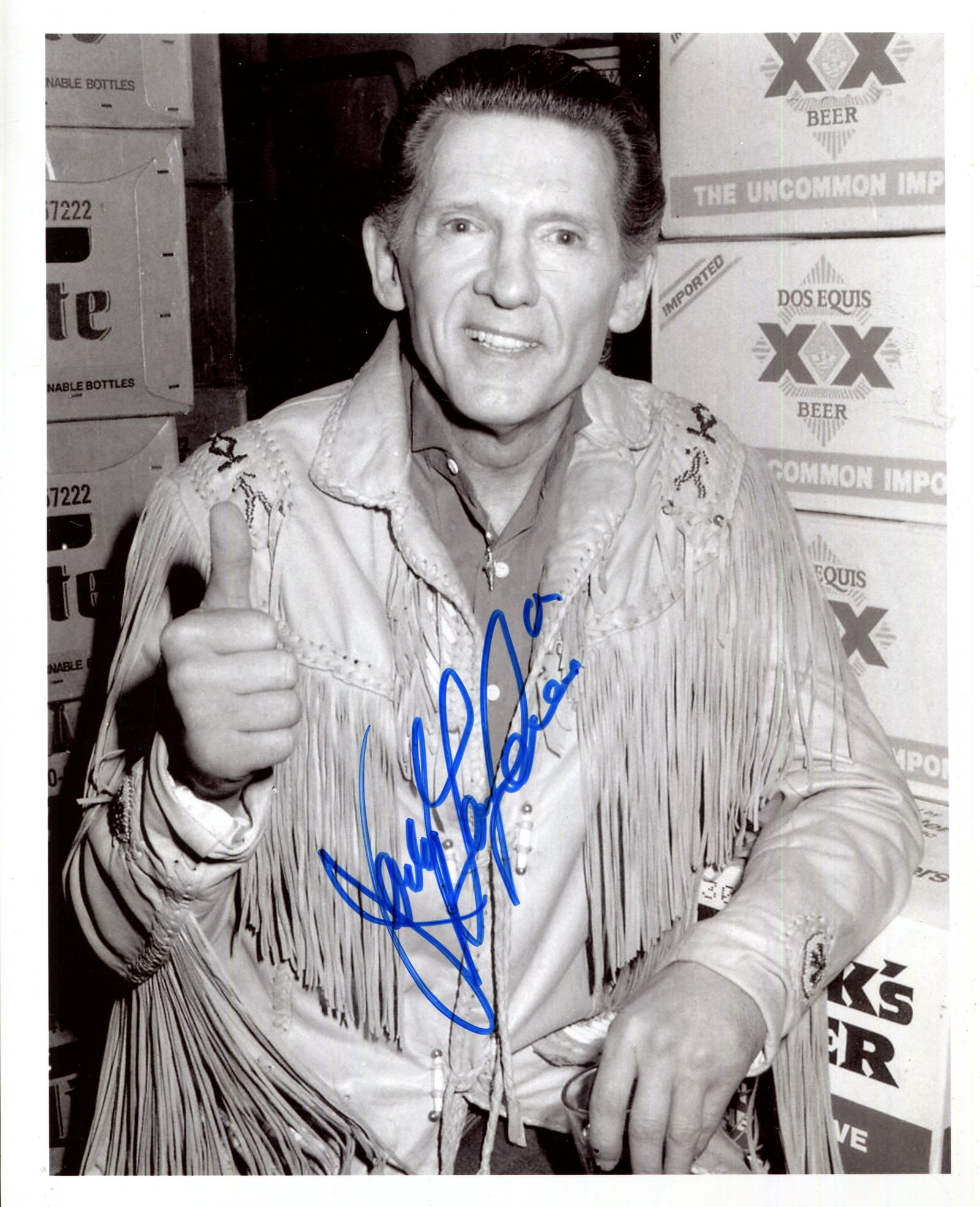 LEWIS JERRY LEE: (1935-2022): LEWIS JERRY LEE: (1935-2022) American rock ‘n’ roll singer. Signed 8 x 10 photograph of the elderly Lewis standing in a half-length pose surrounded by various boxes of beer and with the