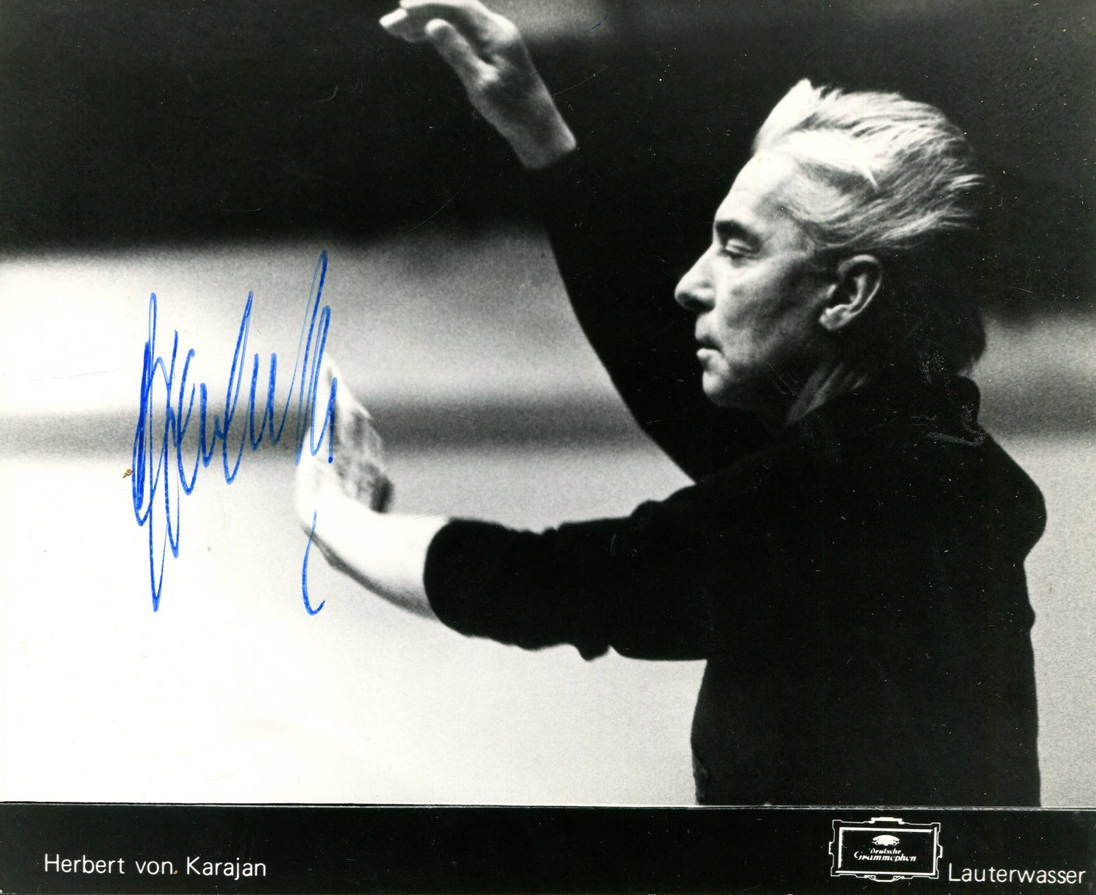 KARAJAN HERBERT VON: (1908-1989): KARAJAN HERBERT VON: (1908-1989) Austrian Conductor. A very fine signed 8.5 x 7 photograph, the promotional Deutsche Grammophon image depicting Karajan in a half length pose conducting during a