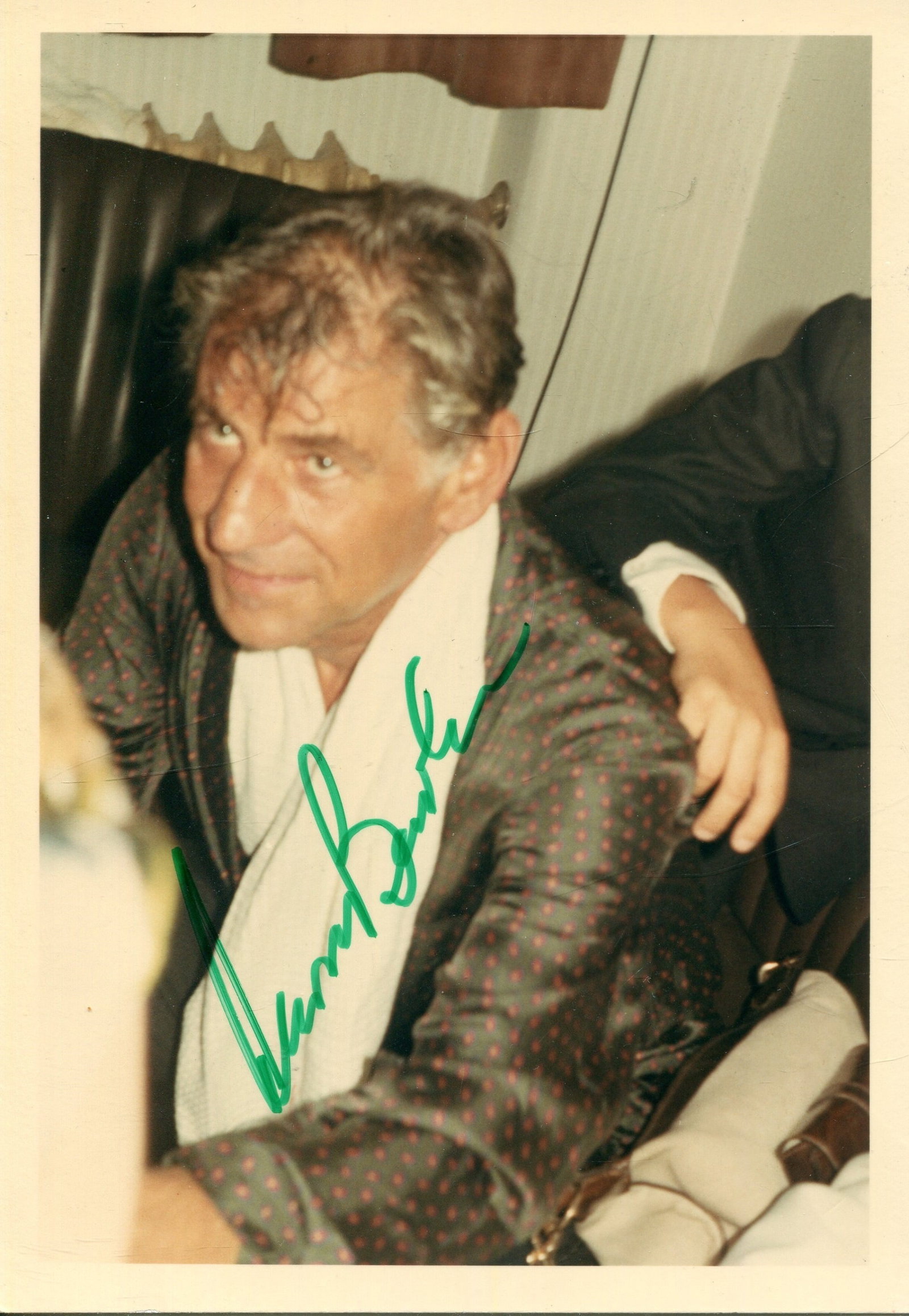 BERNSTEIN LEONARD: (1918-1990): BERNSTEIN LEONARD: (1918-1990) American Conductor & Composer of West Side Story (1957). Signed 3.5 x 5 colour photograph of Bernstein, the image depicting the conductor seated in a half-length pose