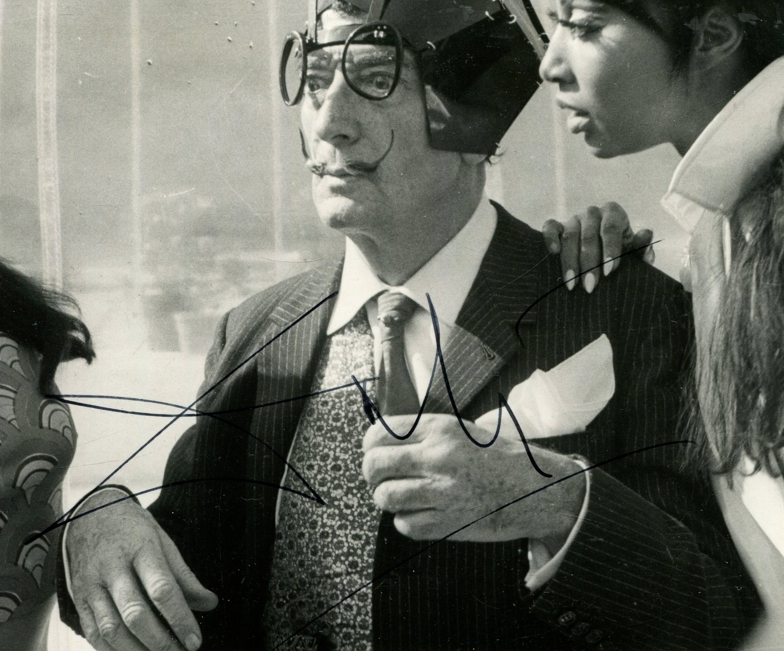 DALI SALVADOR: (1904-1989): DALI SALVADOR: (1904-1989) Spanish surrealist artist. Ubusual signed 5 x 4 photograph by Dali, the United Press International image from London depicting the Spanish artist seated in a half-length