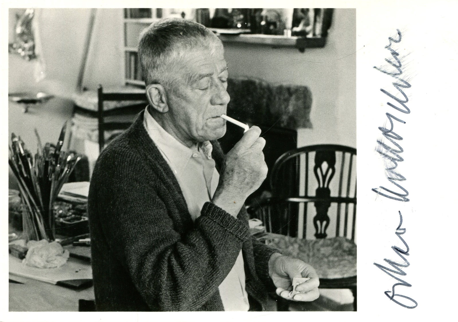KOKOSCHKA OSKAR: (1886-1980): KOKOSCHKA OSKAR: (1886-1980) Austrian Expressionistic Artist and Poet. Signed 6 x 4 photograph, the unusual G. Fehr image showing the artist in his workshop, in a half length pose, lighting a