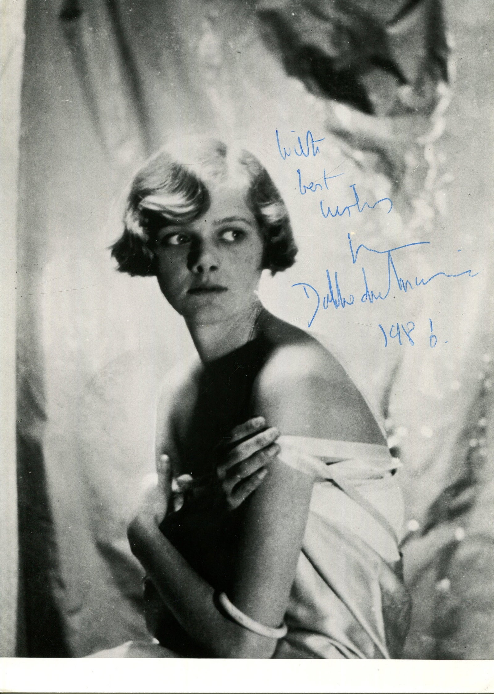 DU MAURIER DAPHNE: (1907-1989): DU MAURIER DAPHNE: (1907-1989) English novelist. Signed 5 x 7 photograph, a later print of an image of the young writer seated in a half-length pose. Signed in blue ink across a lighter area of the