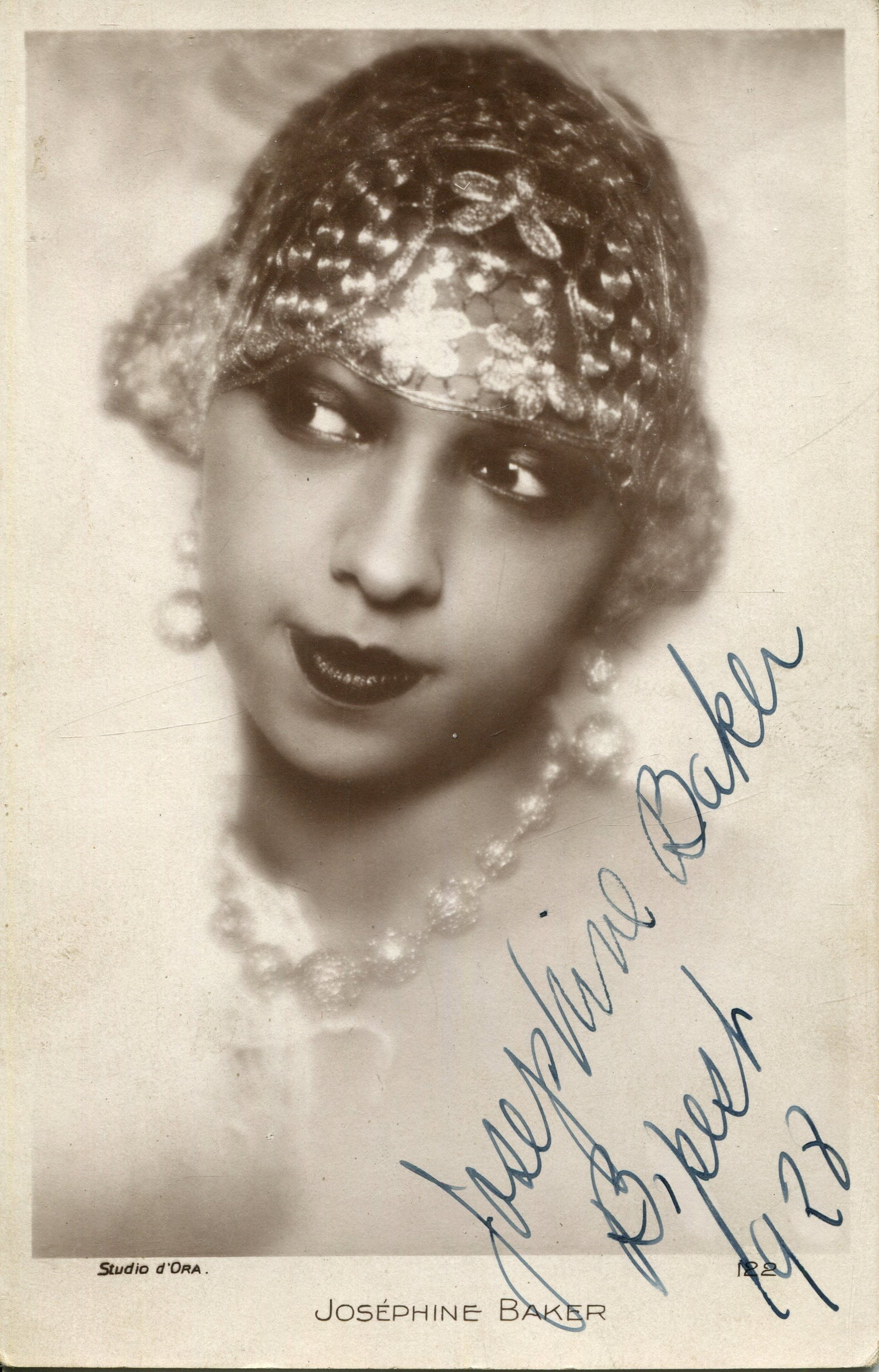 BAKER JOSEPHINE: (1906-1975): BAKER JOSEPHINE: (1906-1975) American-born French entertainer. A good vintage signed 3.5 x 5.5 postcard photograph of Baker in an appealing head and shoulders pose wearing a shimmering headdress.
