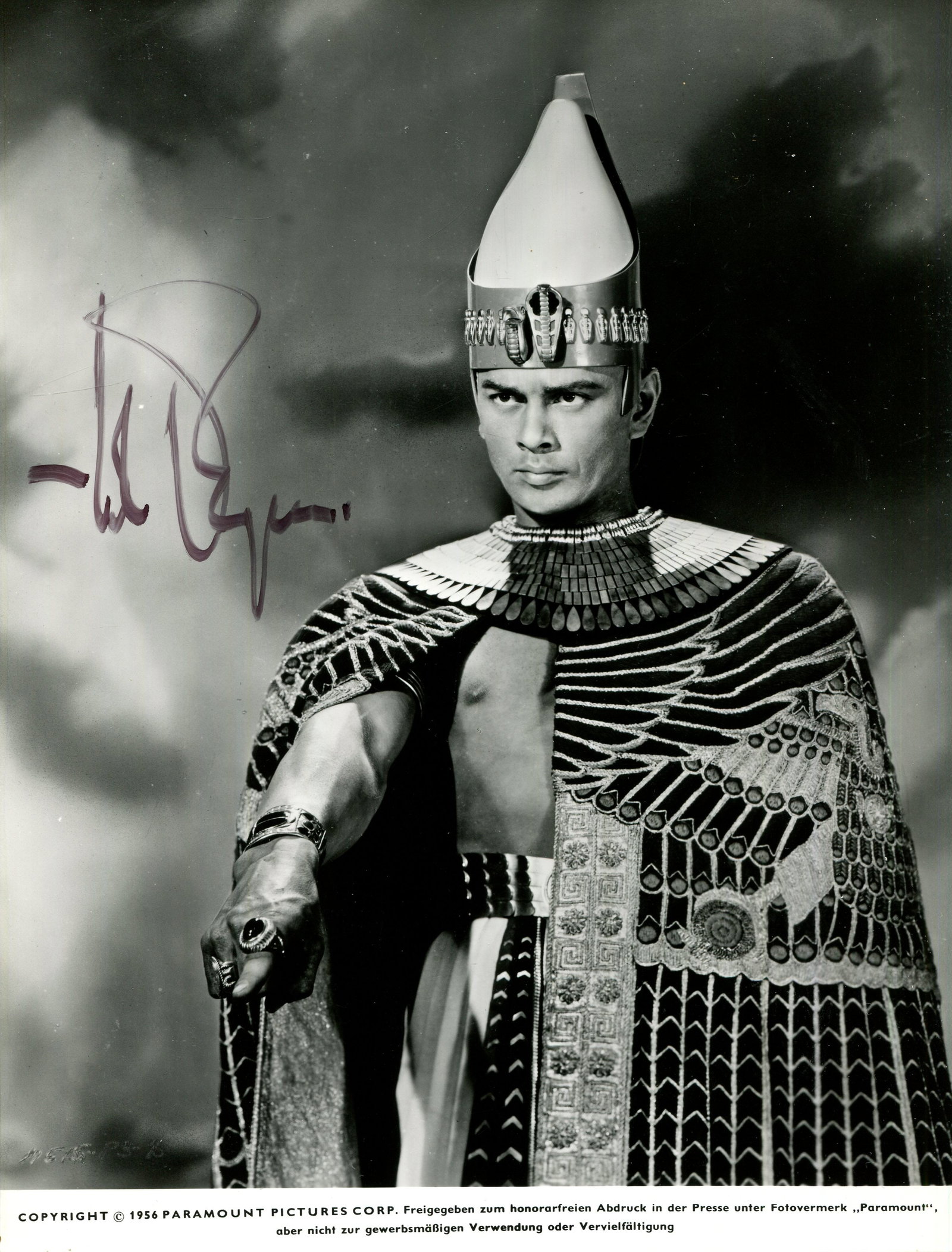 BRYNNER YUL: (1920-1985): BRYNNER YUL: (1920-1985) Russian-born actor, Academy Award winner for Best Actor in 1956 for his role as King Mongkut of Siam in The King and I. Signed 7 x 9.5 photograph of Brynner standing in a