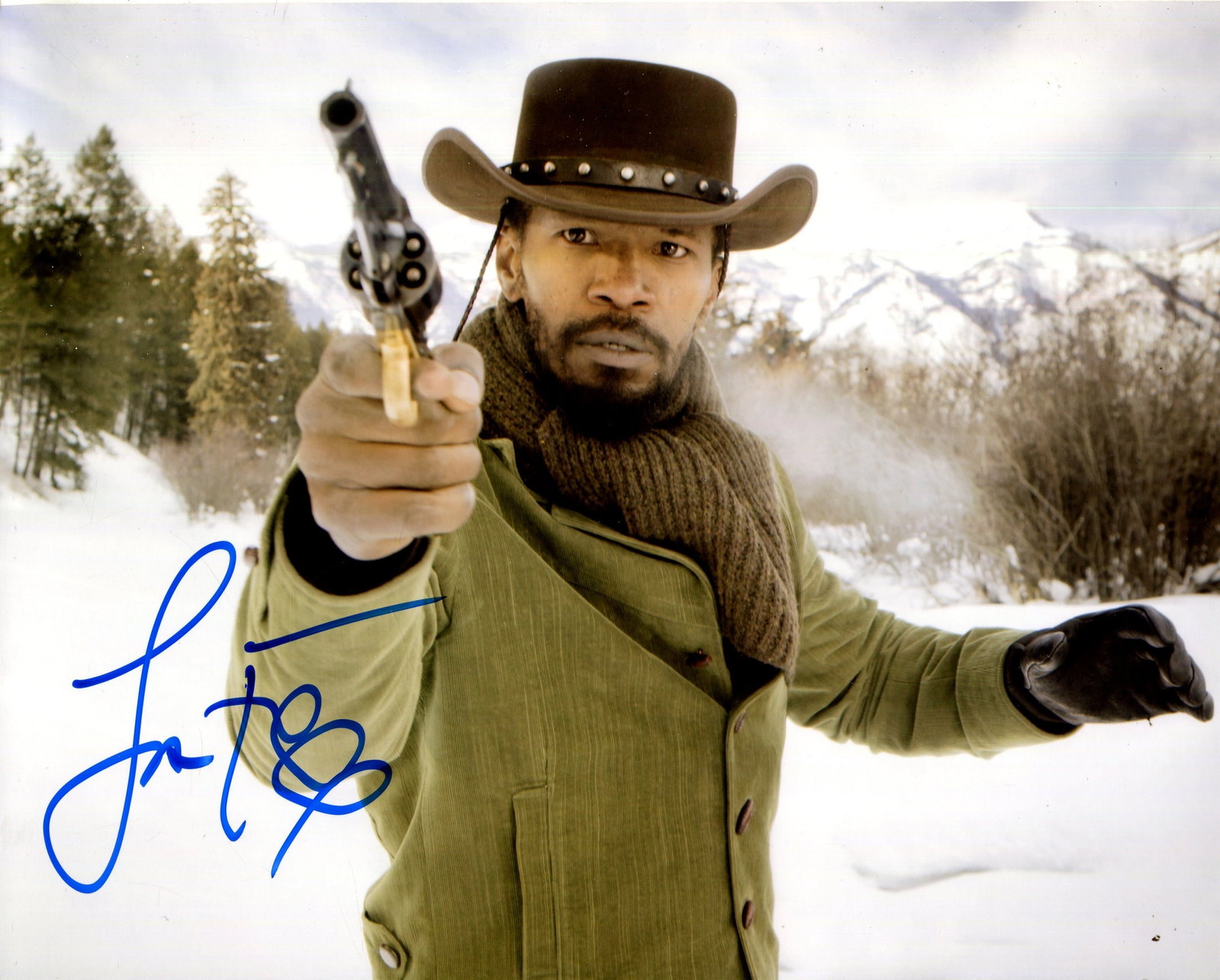 FOXX JAMIE: (1967- ): FOXX JAMIE: (1967- ) American Actor, Academy Award winner. Signed colour 10 x 8 photograph of the actor standing outdoors in a half-length pose, aiming a revolver, in costume as Django in a scene