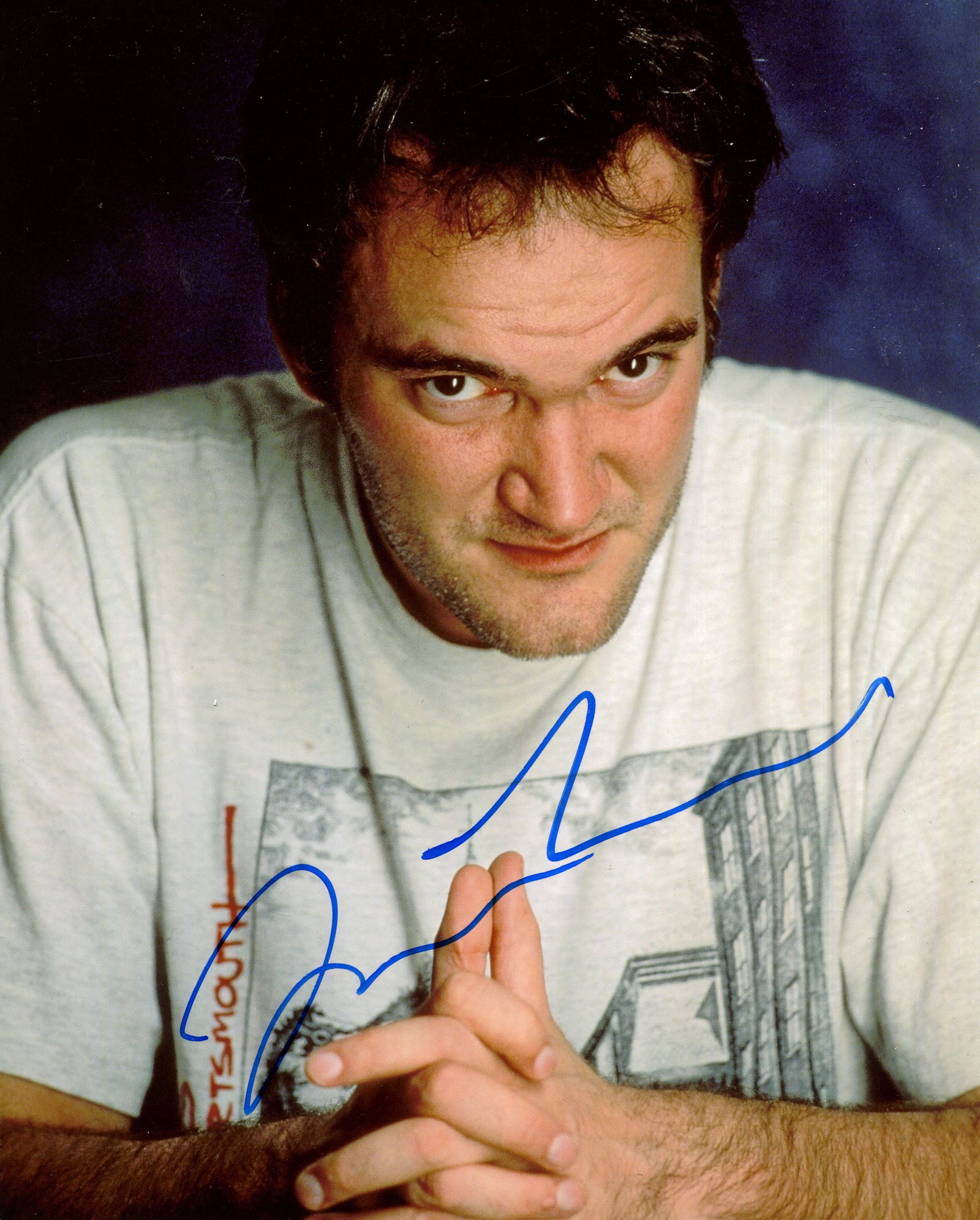 TARANTINO QUENTIN: (1963- ): TARANTINO QUENTIN: (1963- ) American Film Director, Academy Award winner. Signed colour 8 x 10 photograph of the director in a head and shoulders pose with his hands clasped. Signed in blue ink, and