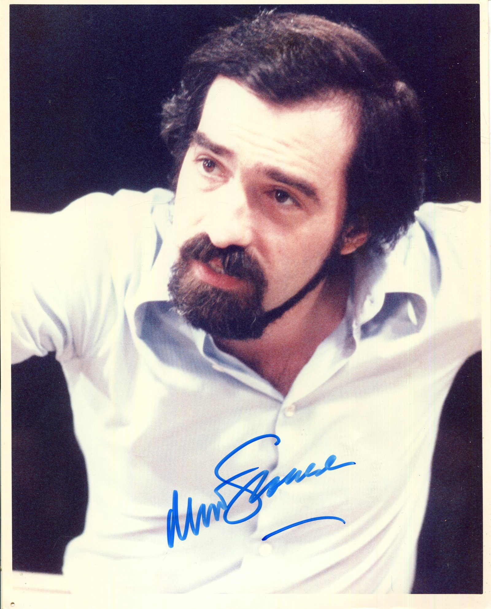 SCORSESE MARTIN: (1942- ): SCORSESE MARTIN: (1942- ) American film director, Academy Award winner. Signed colour 8 x 10 photograph of Scorsese in a half-length pose. Signed in bold blue ink with his name alone to a lighter