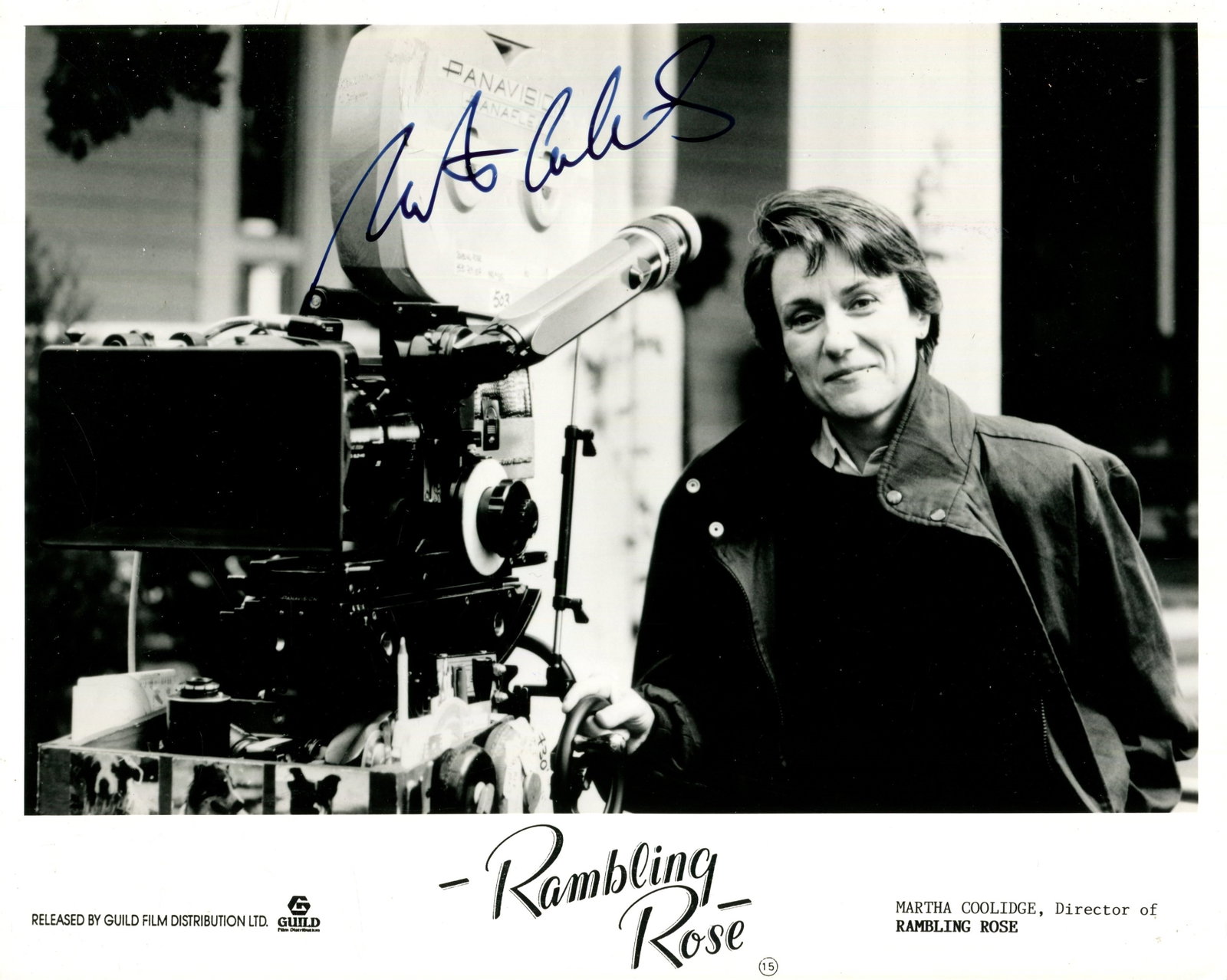 COOLIDGE MARTHA: (1946- ): COOLIDGE MARTHA: (1946- ) American film director. Signed 10 x 8 photograph of Coolidge standing outdoors in a half.-length pose, alongside a large camera, on the set of her drama film Rambling Rose